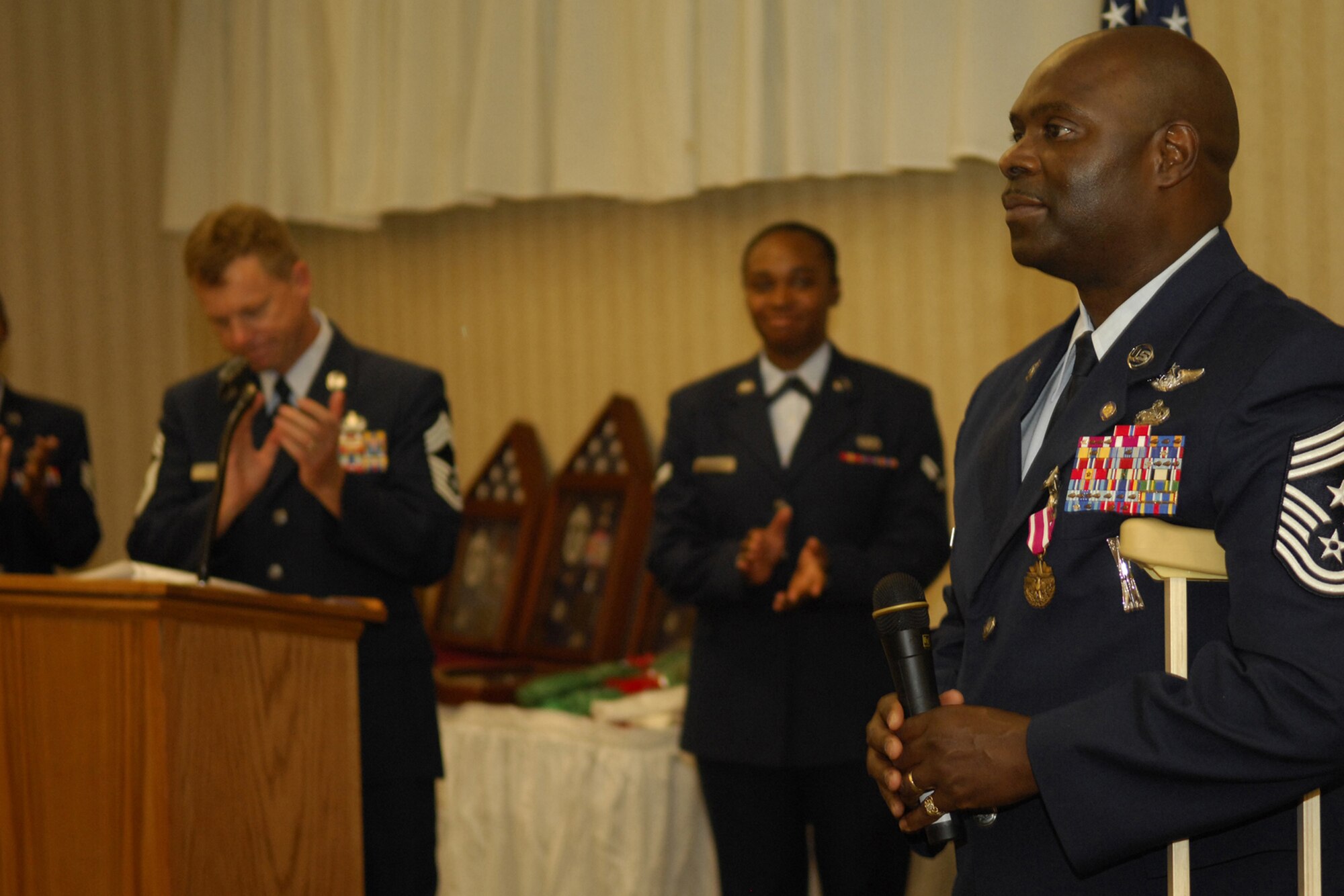 Former Command Chief Master Sergeant Henry Morgan receives applause before he speaks during his retirement ceremony here Dec. 14. Chief Morgan served 30 years in the United States Air Force. (U.S. Air Force Photo by Senior Airman Elizabeth Rissmiller)
