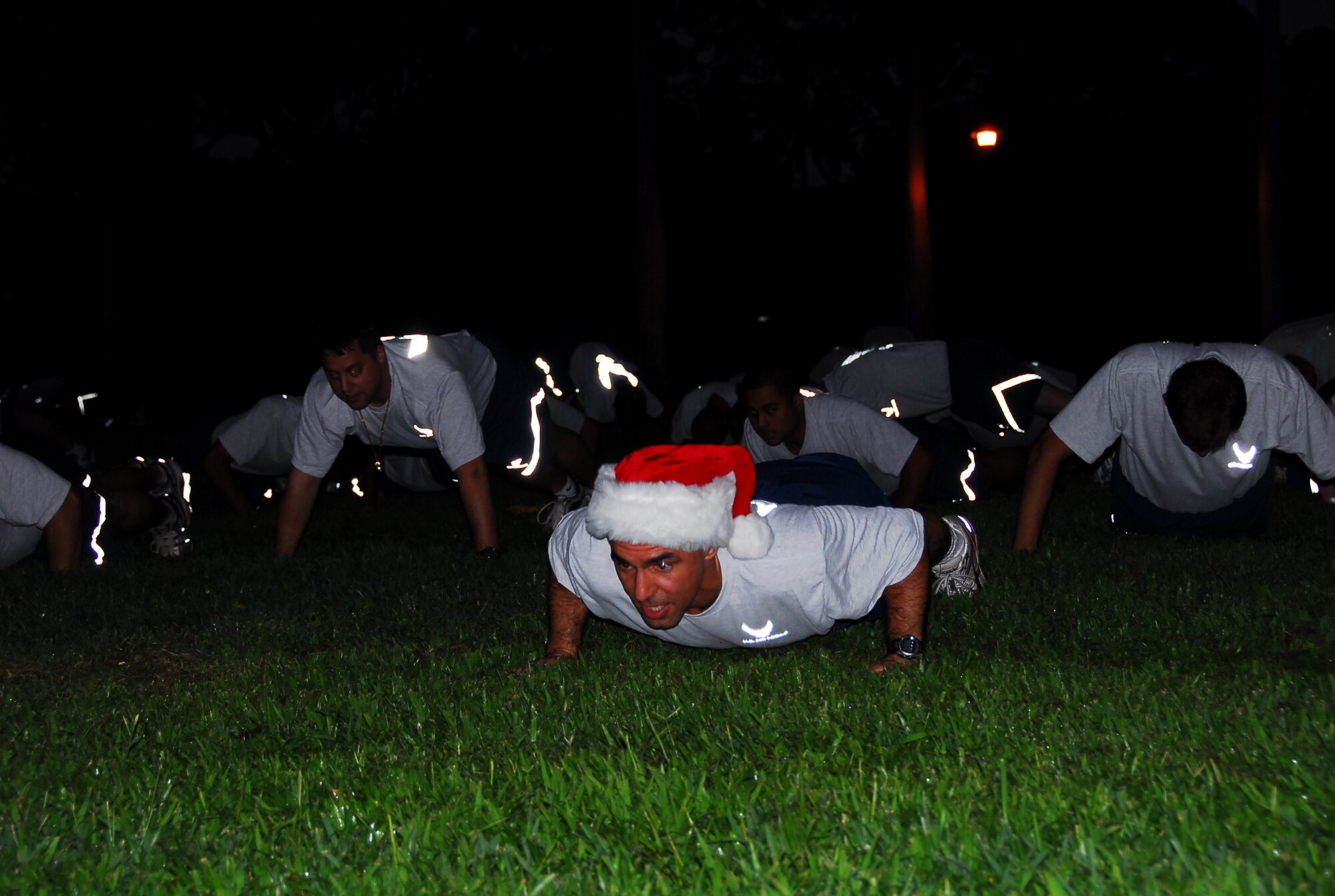 Col. J.J. Torres, 15th Airlift Wing Commander, leads Team Hickam members through push-ups and sit-ups before starting the run. The Team Hickam Warrior Run is a monthly 3-mile fun-run, designed to boost camaraderie between Hickam members. Photo by Ed Foster.