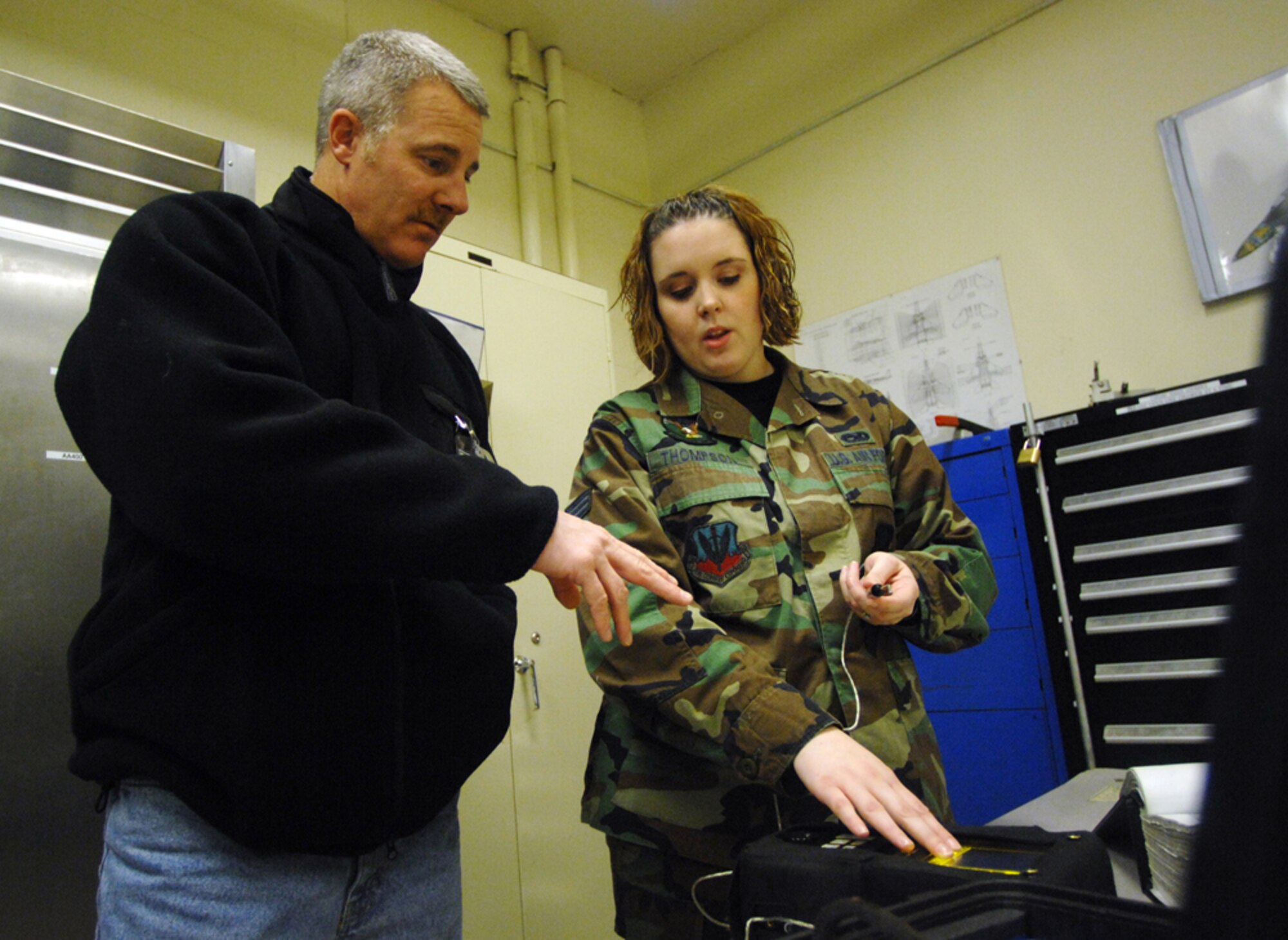 MOUNTAIN HOME AIR FORCE BASE, Idaho -- Senior Airman Delina Thompson, 366th Equipment Maintenance Squadron, shows honorary commander Brian Schroeder equipment used to inspect F-15 models for structural damage during their tour here, Dec 7. The visit provided more than 20 of the wing’s honorary commanders an interactive, hands-on experience of maintenance operations and the opportunity to meet the Airmen who make it happen. (U.S. Air Force photo/ Airman 1st Class Ryan Crane)