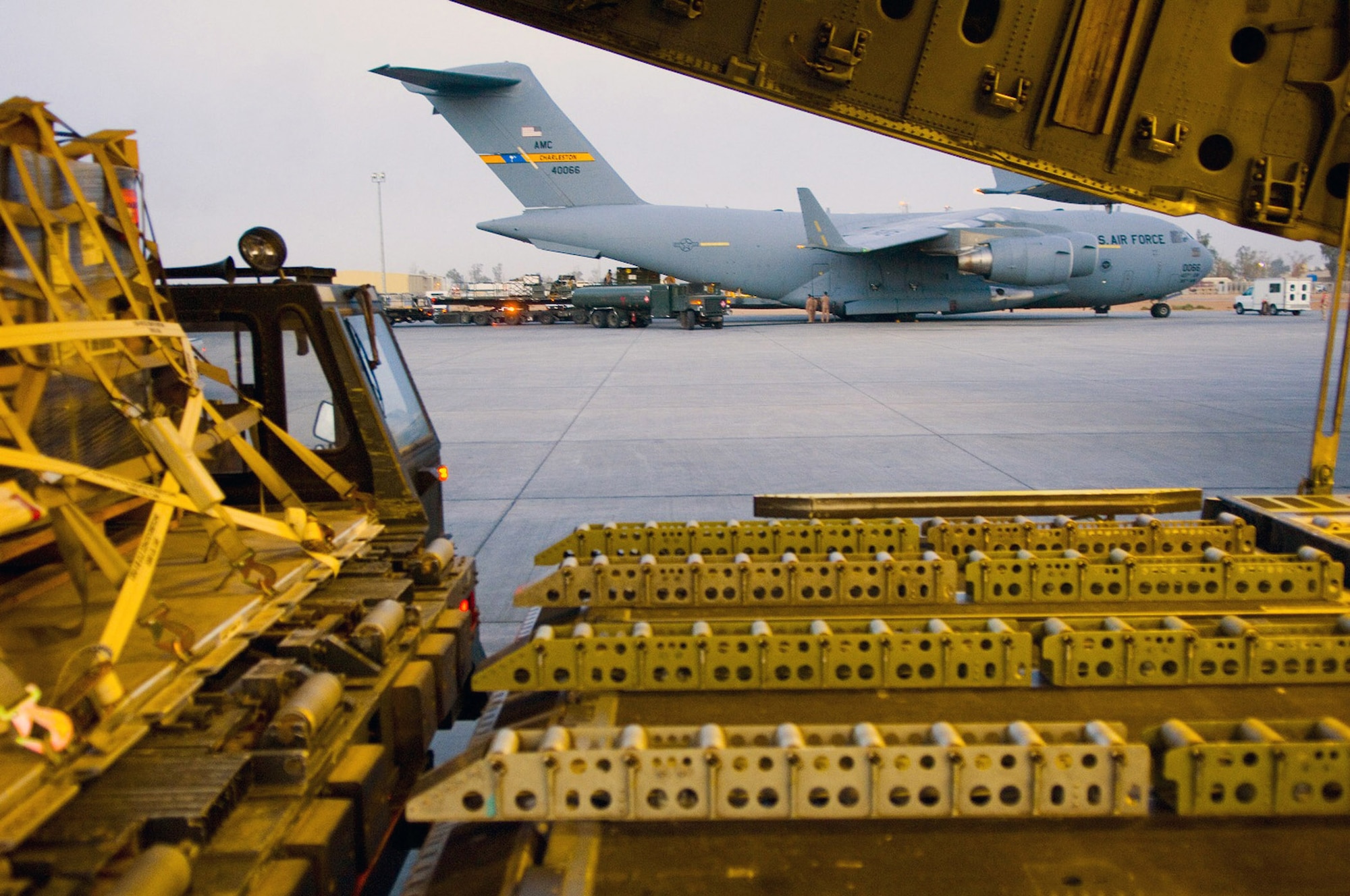 C-17 Globemaster IIIs play a key part in delivering supplies to bases around the area of operations in Southwest Asia. C-17s were among the aircraft downloaded by 332nd Expeditionary Logistics Readiness Squadron Aerial Port Flight members to break the previous single-day cargo movement record by more than 100 tons Dec. 6 at Balad Air Base, Iraq. (U.S. Air Force photo/Staff Sgt. Travis Edwards)