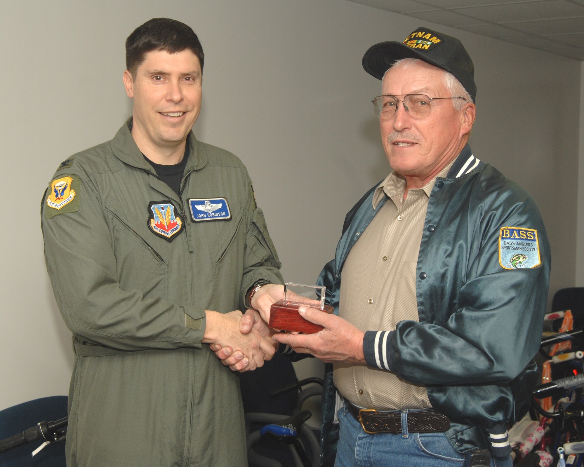 WHITEMAN AIR FORCE BASE, Mo.— Col. John Robinson, 509th Bomb Wing vice commander, presents a memento to Richard Svitak, father of the late Sergeant Philip J. Svitak who died in Afghanistan on March 4, 2002. The Philip Svitak Bicycle Benefit donated more than 40 bikes to the Whiteman Airman and Family Readiness Center, Dec. 17. (U.S. Air Force photo/Airman 1st Class Stephanie Clark)