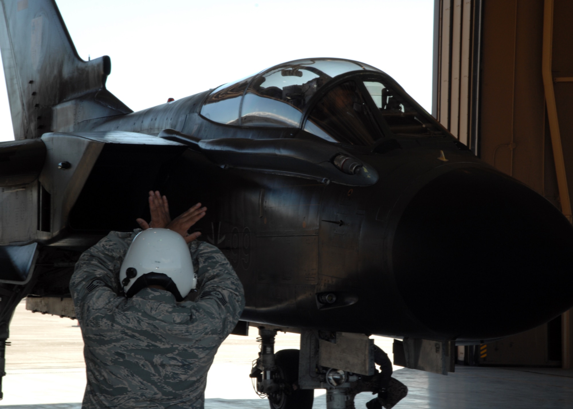 Staff Sgt. Romeo Casuga, 49th Aircraft Maintenance Squadron,  marshalls a Tornado flown by Lt. Col. Alexander Jung, German Air Force Tornado Training Squadron, and Brig. Gen. David Goldfein, 49th Fighter Wing commander, Dec. 14, 2007, at Holloman Air Force Base, N.M. This was Brig. Gen. Goldfein's first ride in the Tornado. (U.S. Air Force photo/Airman 1st Class Jamal D. Sutter)