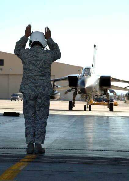 Staff Sgt. Romeo Casuga, 49th Aircraft Maintenance Squadron,  marshalls a German Tornado flown by Lt. Col. Alexander Jung, German Air Force Tornado Training Squadron, and Brig. Gen. David Goldfein, 49th Fighter Wing commander, Dec. 14, 2007, at Holloman Air Force Base, N.M. This was Brig. Gen. Goldfein's first ride in the Tornado. (U.S. Air Force photo/Airman 1st Class Jamal D. Sutter)