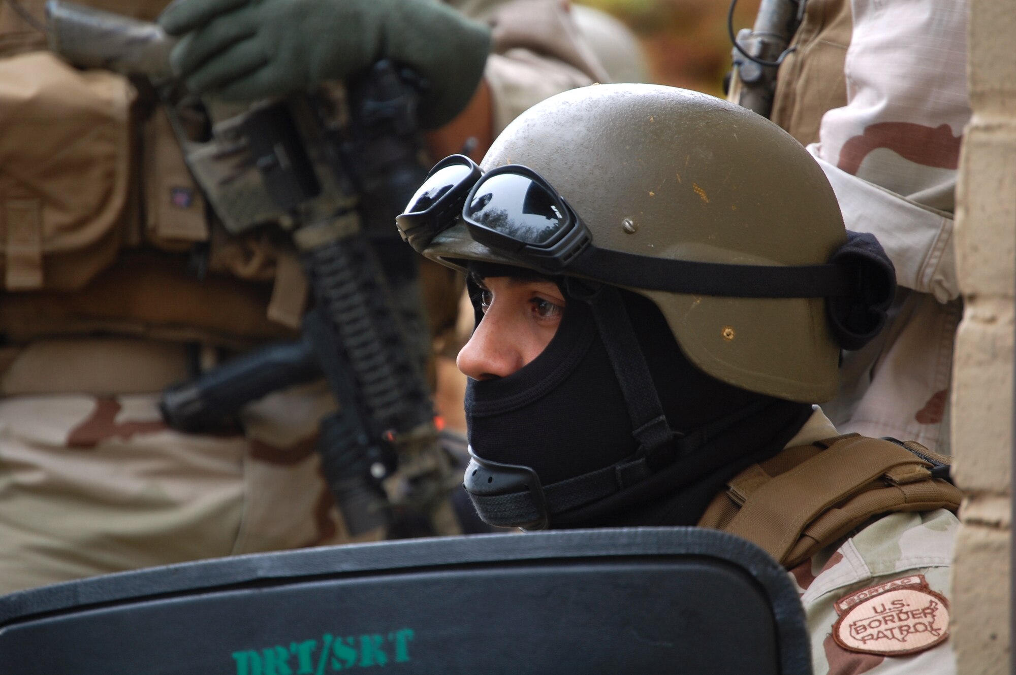 LAUGHLIN AIR FORCE BASE, Texas – A member of a Special Response Team with the Del Rio, Texas Border Patrol anxiously waits with fellow team members to engage in a potentially dangerous hostage altercation. Laughlin members work along side Border Patrol and Federal Bureau of Investigation agents to learn how they operate under different situations. Laughlin conducts base-wide exercises often in order to prepare members for incidents and other contingency operations. (U.S. Air Force photo by Airman 1st Class Sara Csurilla)