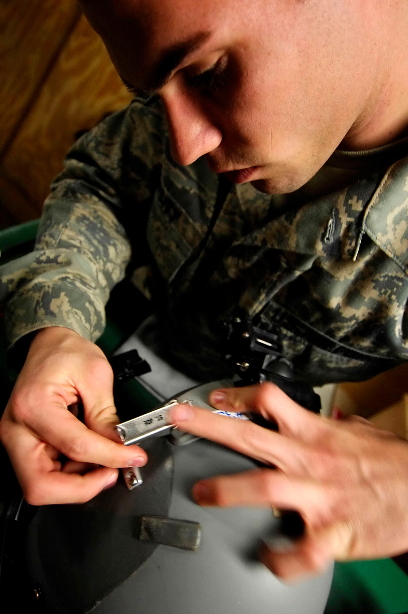 Senior Airman Jordan Cassity attaches a night-vision bracket to an aircrew member's helmet Dec. 12 at Bagram Air Base, Afghanistan. Airman Cassity, an aircrew life support technician with the 774th Expeditionary Airlift Squadron, manages and performs inspections, maintenance and adjustments of aircrew life support equipment. (U.S. Air Force photo/Staff Sgt. Joshua T. Jasper)
