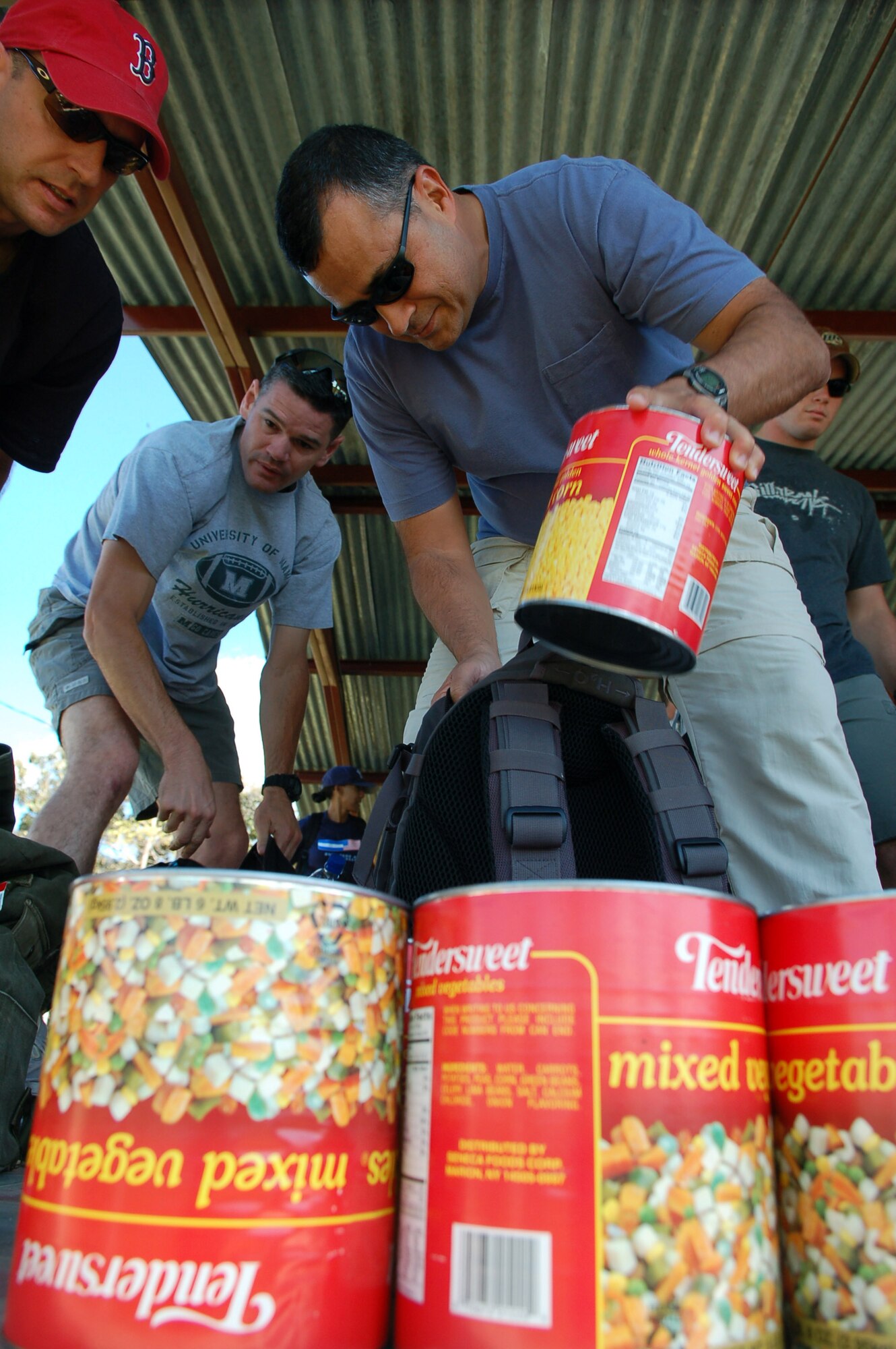 COMAYAGUA, Honduras -- Army Col. Marcus De Oliveira, Joint Task Force-Bravo commander, loads food into his backpack to take to the village of Capiro Dec. 14.  The colonel was one of about 60 people who attended the three-mile JTF-Bravo Chapel-sponsored hike, which was the fourth in a series of five scheduled trips.  (U.S. Air Force photo by Staff Sgt. Austin M. May)
