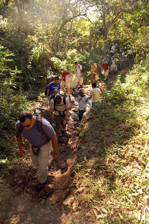 COMAYAGUA, Honduras -- Servicemembers assigned to Joint Task Force-Bravo cross a stream en route to the village of Capiro to deliver approximately 600 pounds of food Dec. 14.  The three-mile hike, sponsored by the JTF-Bravo chapel, was the fourth in a series of five scheduled trips.  (U.S. Air Force photo by Staff Sgt. Austin M. May)
