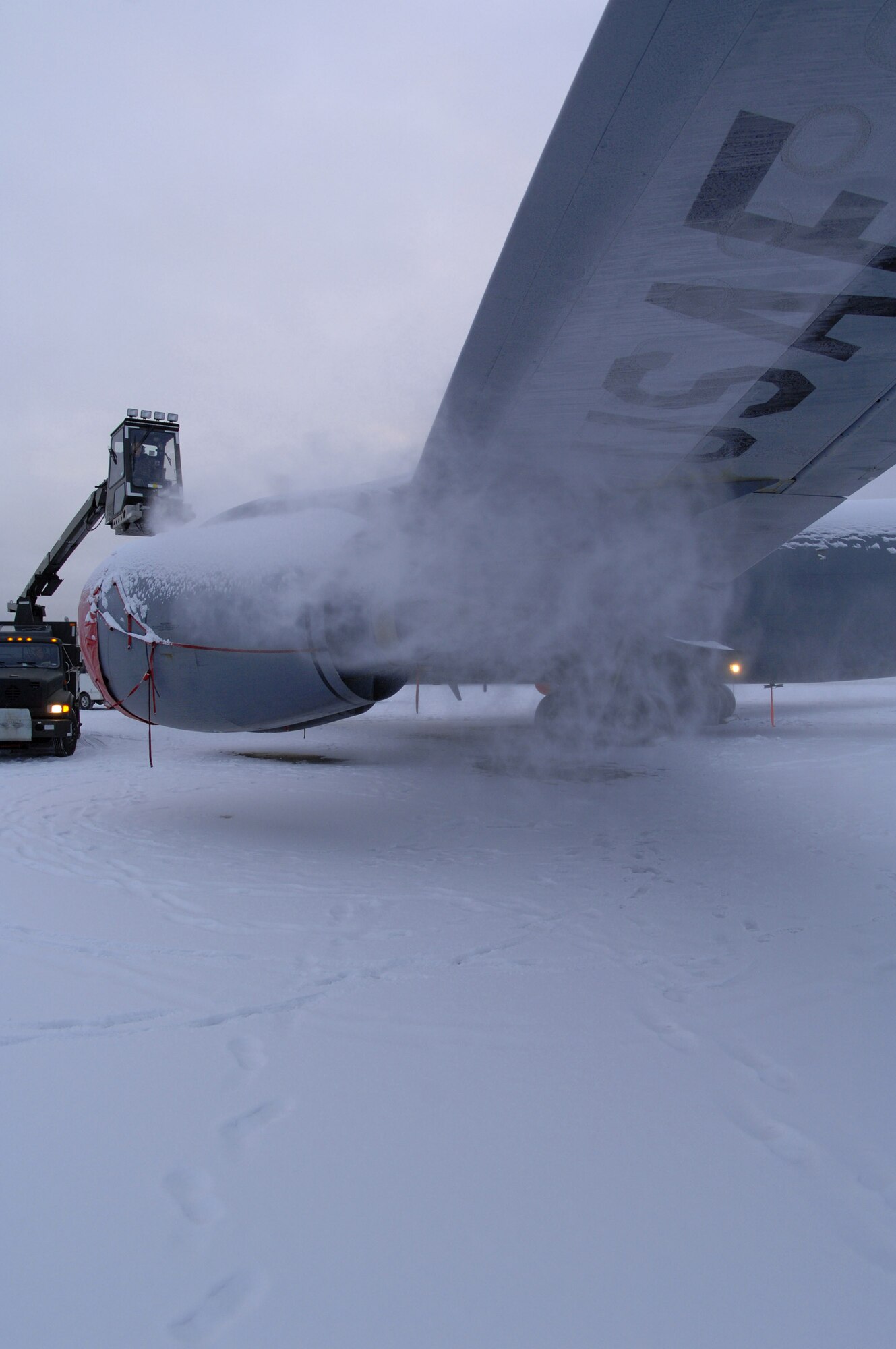 Snow is blown off the engine of a KC-135 Stratotanker during the de-icing process Dec. 12 on the Eielson Air Force Base, Alaska, flightline. Due to the arctic conditions and the continuous snow fall during Alaska's extended winters, Eielson AFB maintainers are on constant standby to assure all aircraft are ready for take-off at moments notice. (U.S. Air Force photo/Airman 1st Class Christopher Griffin) 