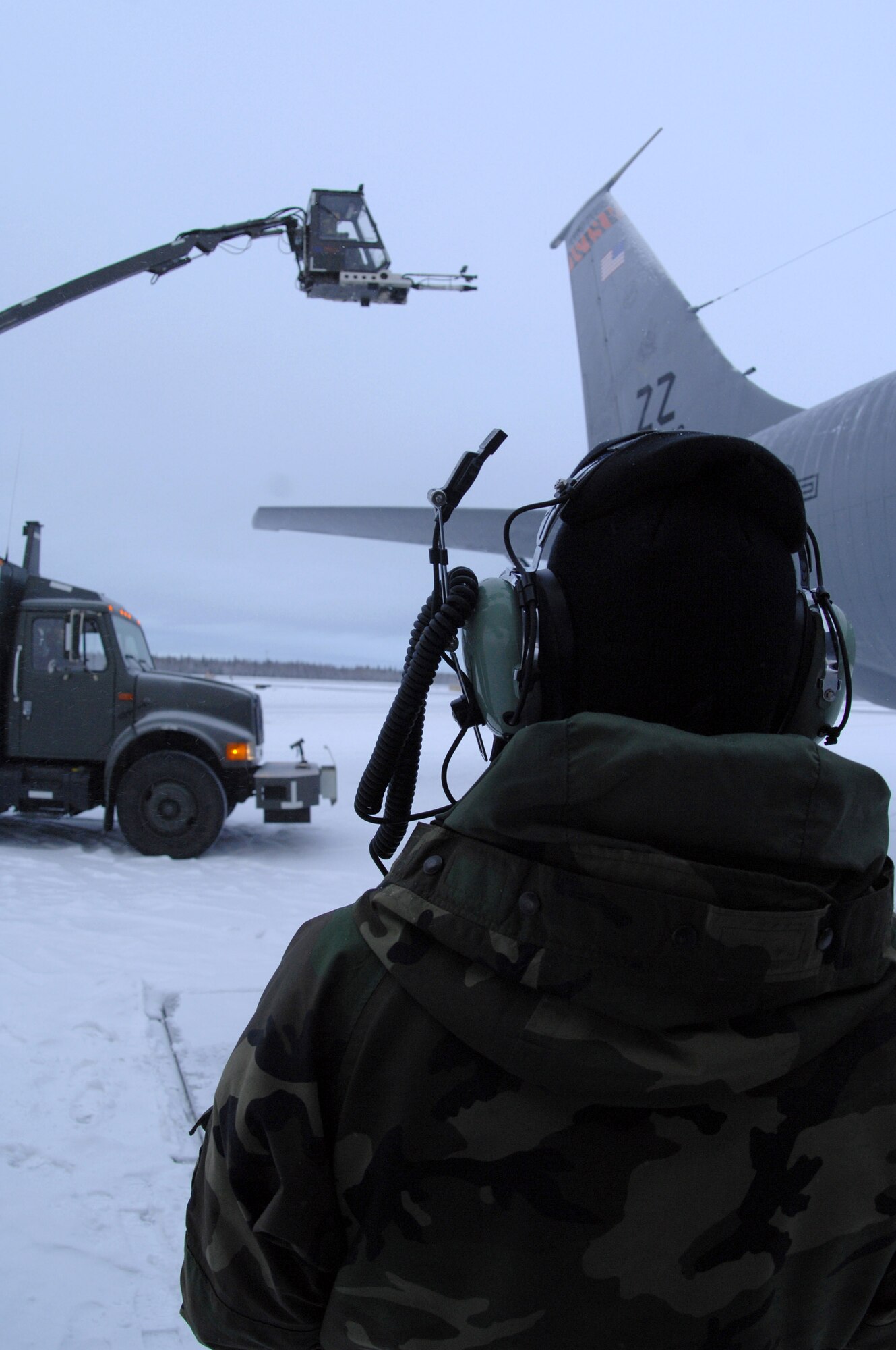 Senior Airman Seth Harbor instructs the operator of the de-icer on where to blow snow off of a KC-135 Stratotanker Dec. 12 on the Eielson Air Force Base, Alaska, flightline. Due to the arctic conditions and the continuous snow fall during Alaska's extended winters, Eielson AFB maintainers are on constant standby to assure all aircraft are ready for take-off at moment's notice. Airman Harbor is with the 354th Aircraft Maintenance Squadron. (U.S. Air Force photo/Airman 1st Class Christopher Griffin) 