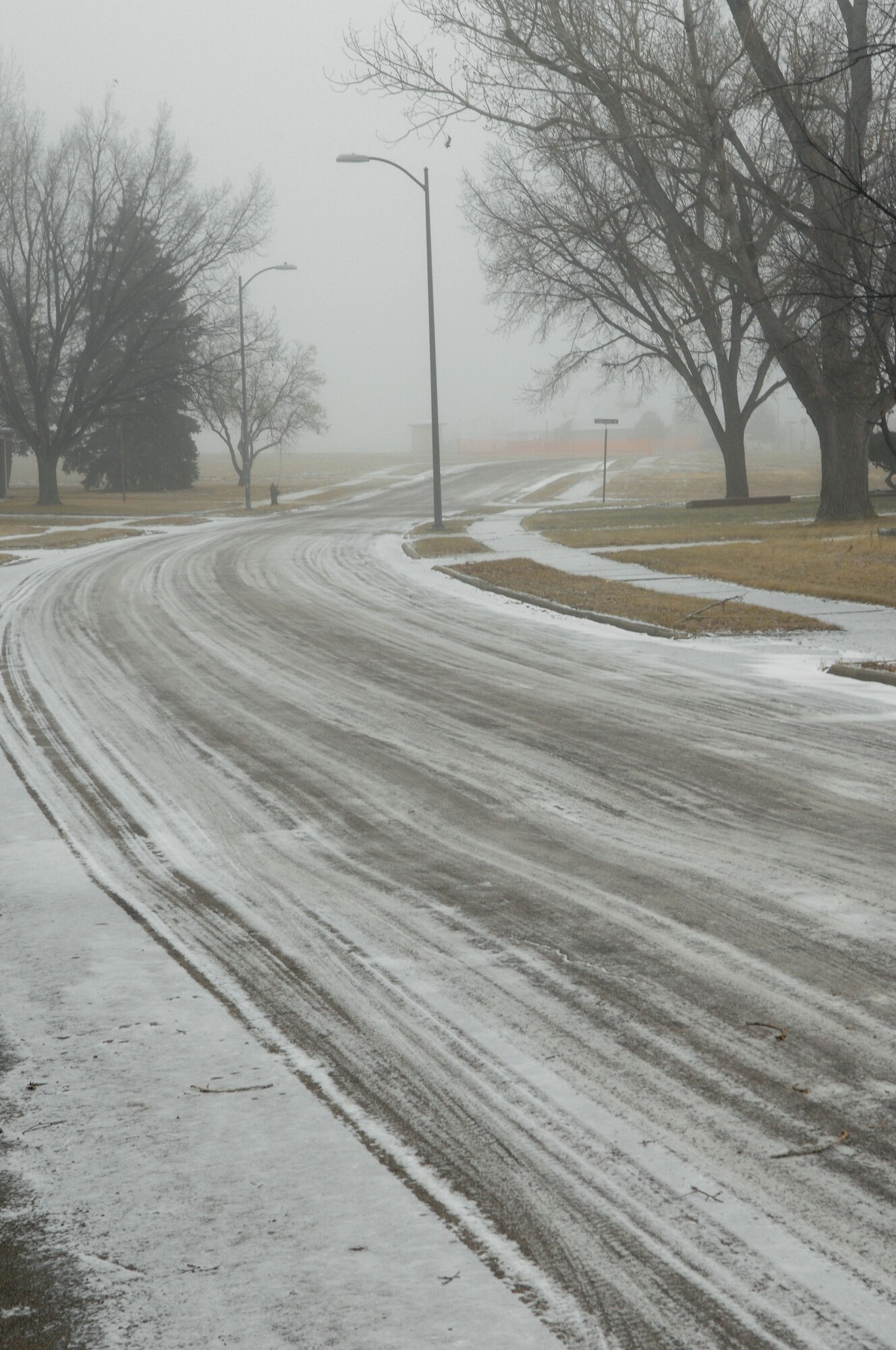 Snow-covered roads make traveling hazardous on Ellsworth after a recent snow storm. Ellsworth road conditions change many times during the winter months, and staying abreast of the most up-to-date traveling conditions may help keep Airmen and their families safe this winter. For current road conditions call 385-ROAD. (U.S. Air Force photo/Airman 1st Class Joshua Seybert)