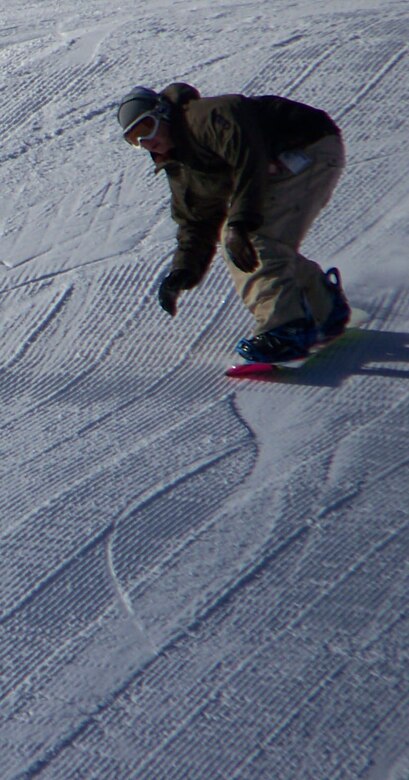 A snowboarder winds his way down the mountain at the Big Sky Resort during Military Appreication Weekend. Big Sky offered reduced room and lift tickets from Dec. 7 to 9, allowing miltiary members to enjoy the slopes at significantly lower prices. (U.S. Air Force photo / Airman 1st Class Emerald Ralston)
