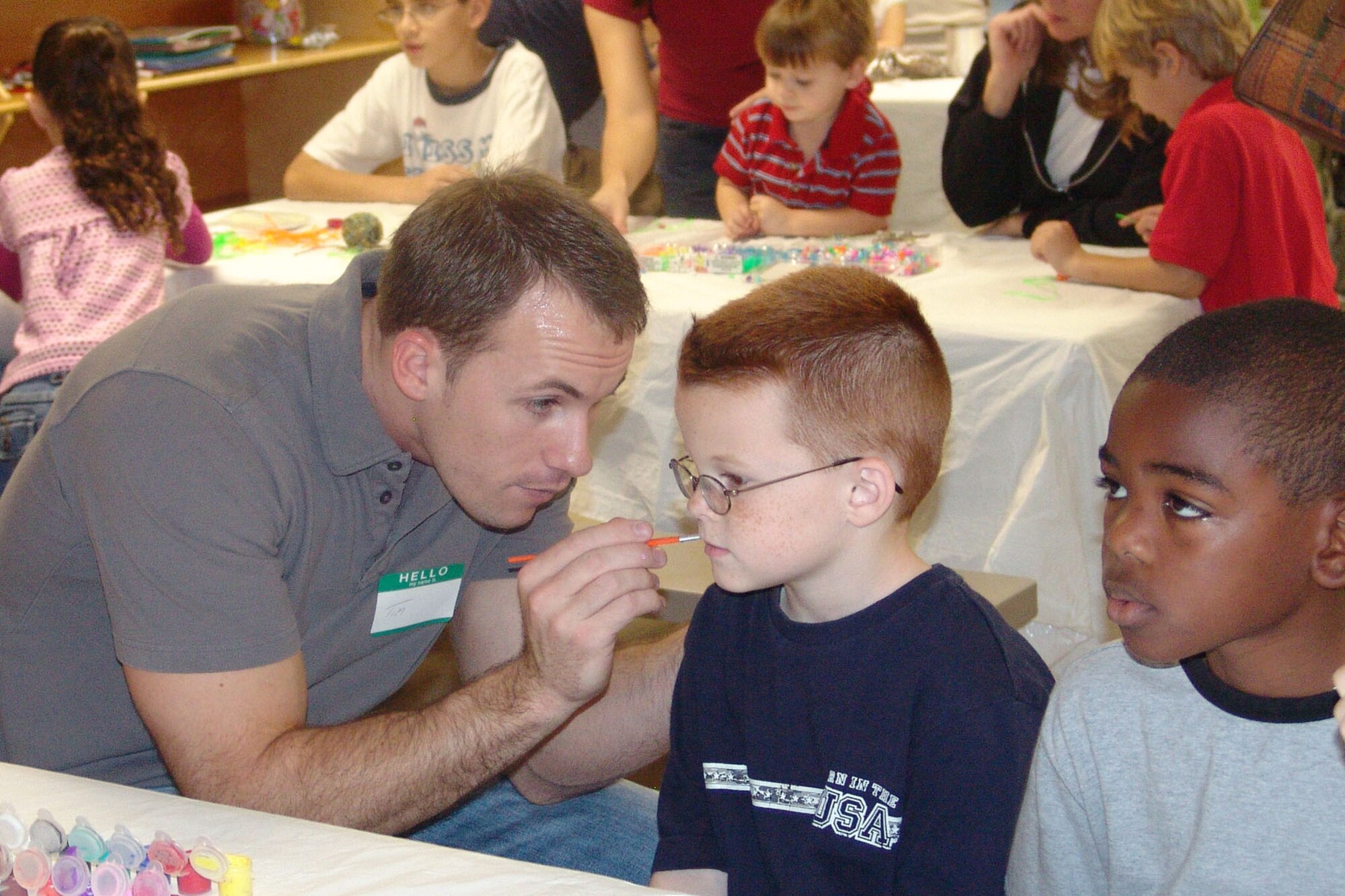 EGLIN AIR FORCE BASE, Fla. -- Tim Amos volunteered his time to paint faces at the Hearts Apart Christmas party. The Airman and Family Readiness Center sponsored the party for more than 100 spouses and their children Dec. 15. (USAF photo by Lois Walsh)