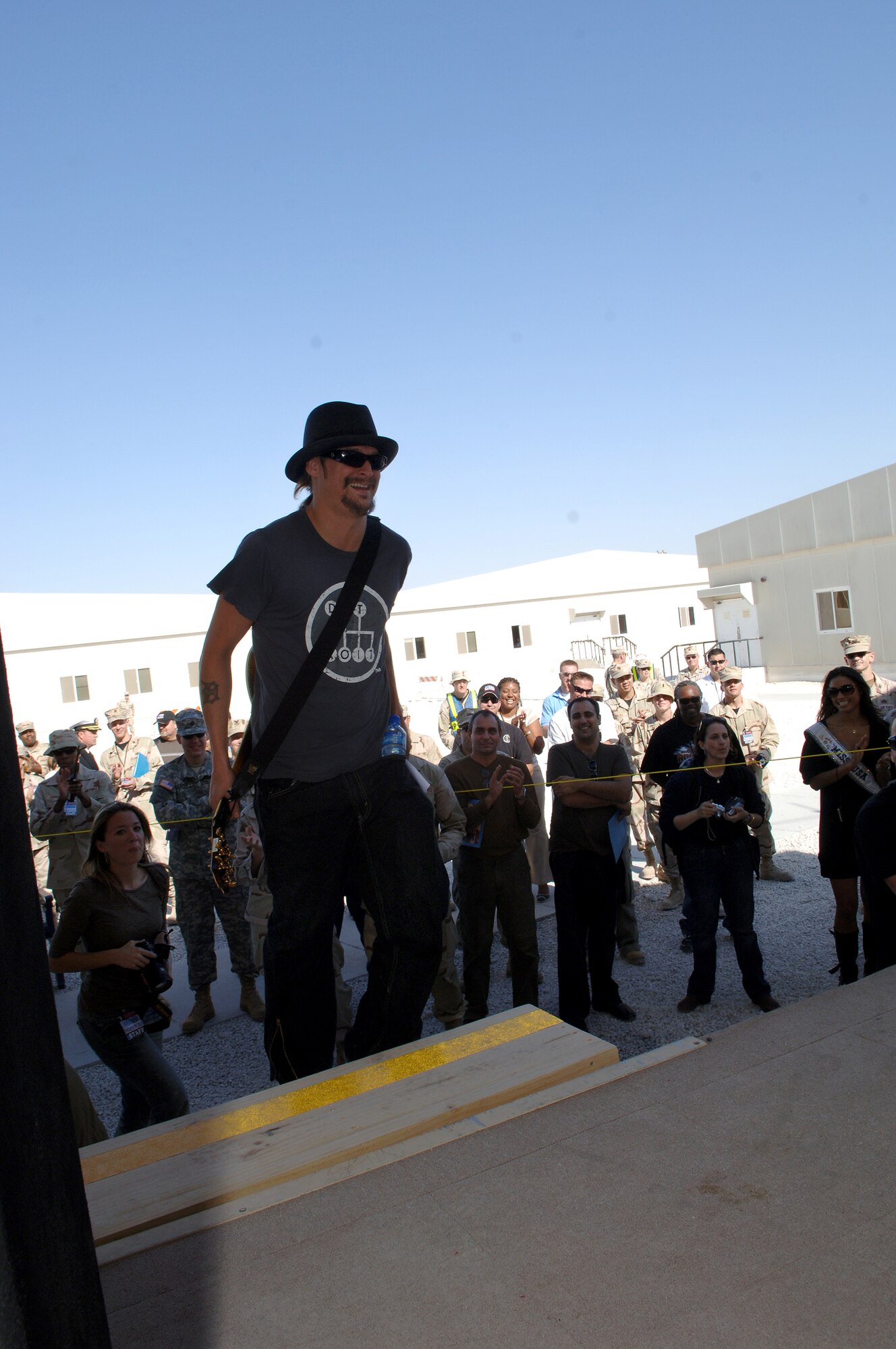 SOUTHWEST ASIA - Kid Rock enters the stage right before performing for troops at the 379th Air Expeditionary Wings Memorial Plaza at a Southwest Asia air base.  Kid Rock is part of the United Service Organizations 2007 holiday tour. (U.S. Air Force photo/Master Sgt. Greg Kunkle) 