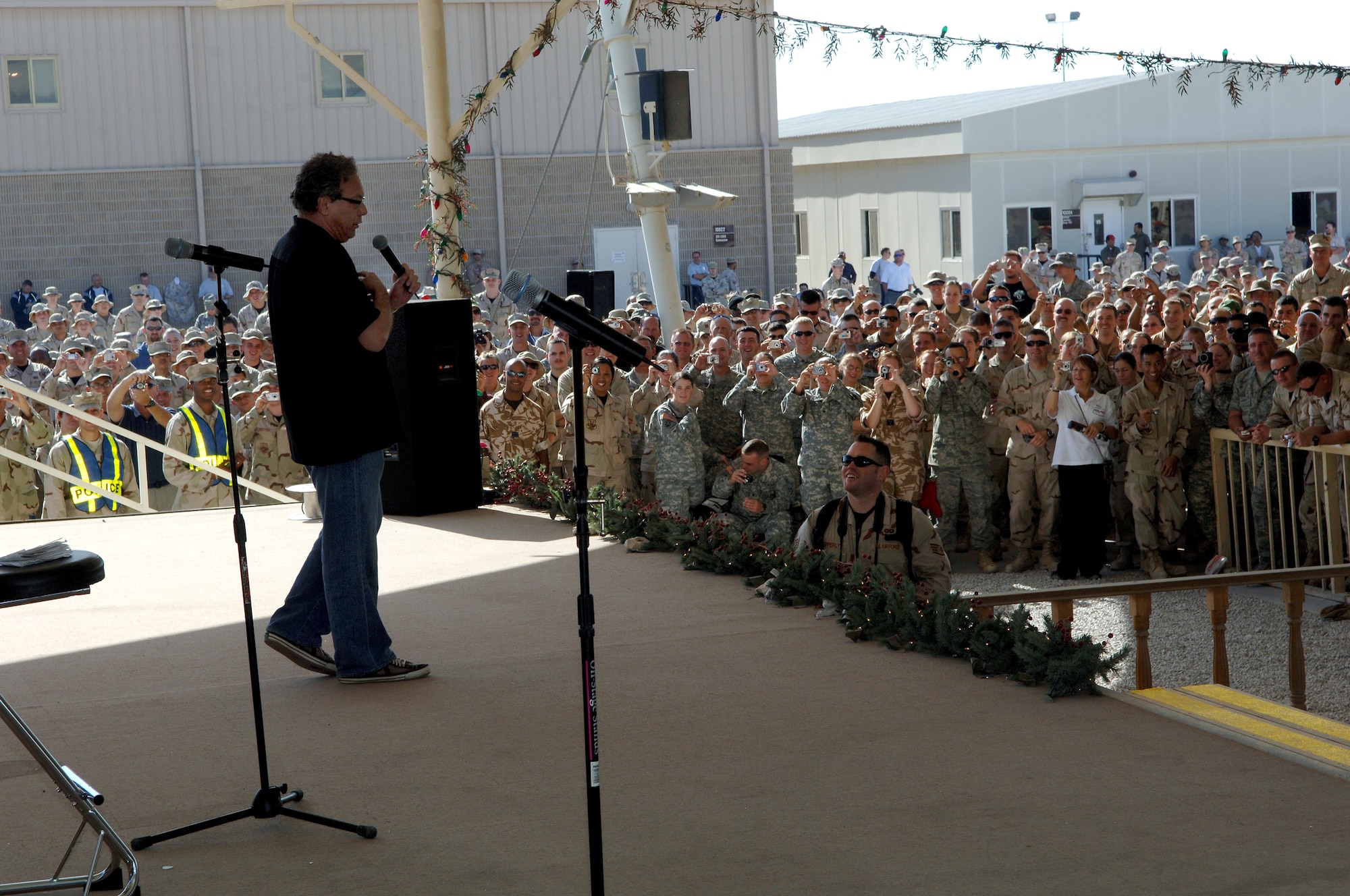 SOUTHWEST ASIA - Lewis Black, comedian and actor,  entertains deployed troops Dec. 17 at a base in Southwest Asia as part of the USO 2007 holiday tour. Other celebrities on the tour included Rachel Smith, Miss USA, Robin Williams, Kid Rock and Lance Armstrong. (Air Force Photo by Master Sergeant Greg Kunkle)