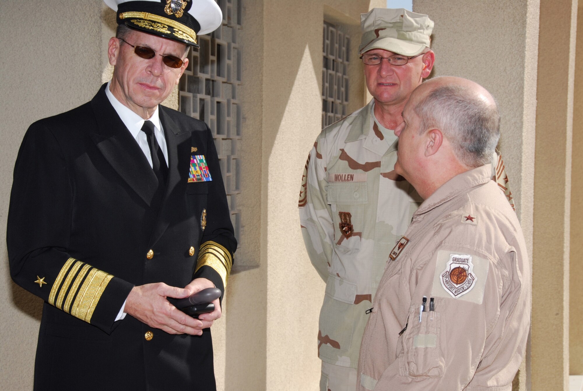 SOUTHWEST ASIA - Admiral Mike Mullen, chairman of Joint Chiefs of Staff, has a few parting words with Brig. Gen. Charlie Lyon, 379th Air Expeditionary Wing commander, and Chief Master Sgt. Lloyd Hollen, 379th AEW command chief, before leaving a Southwest Asia air base Dec. 17. The chairman and his wife, Deborah, are making a tour of the Southwest Asia theater with the USO 2007 holiday show. 
(U. S. Air Force photo/Staff Sgt. Douglas Olsen)