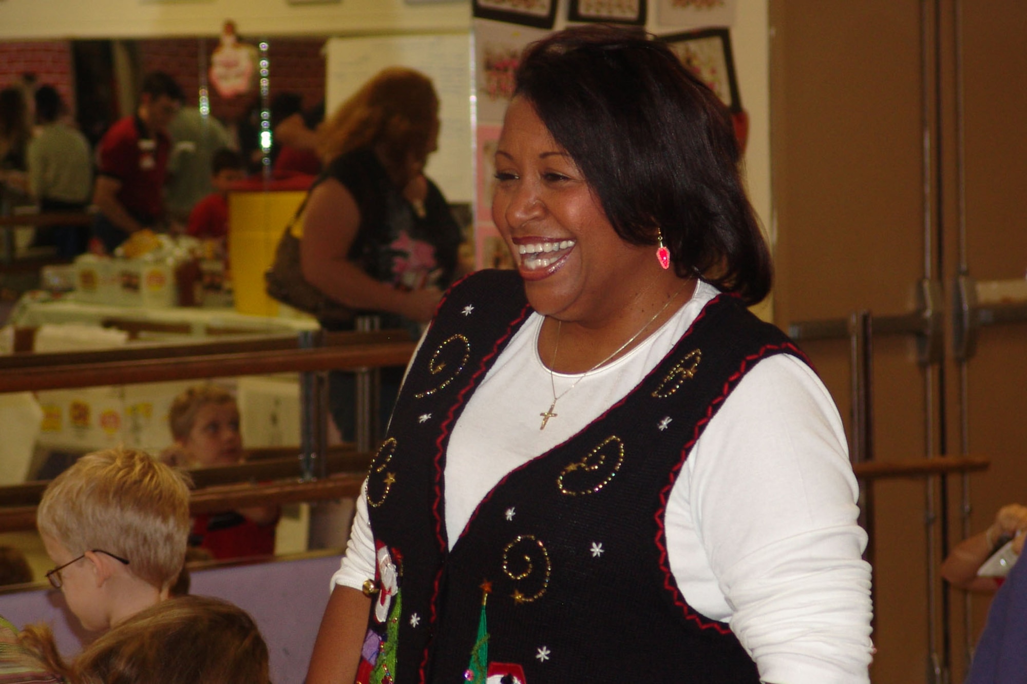 Jiri Crowder, flight chief for the Airman and Family Readiness Center, enjoys the holiday party for deployed spouses. Ms. Crowder was recently named Outstanding Family Support Individual of the Year for the Air Force. (USAF photo by Lois Walsh)