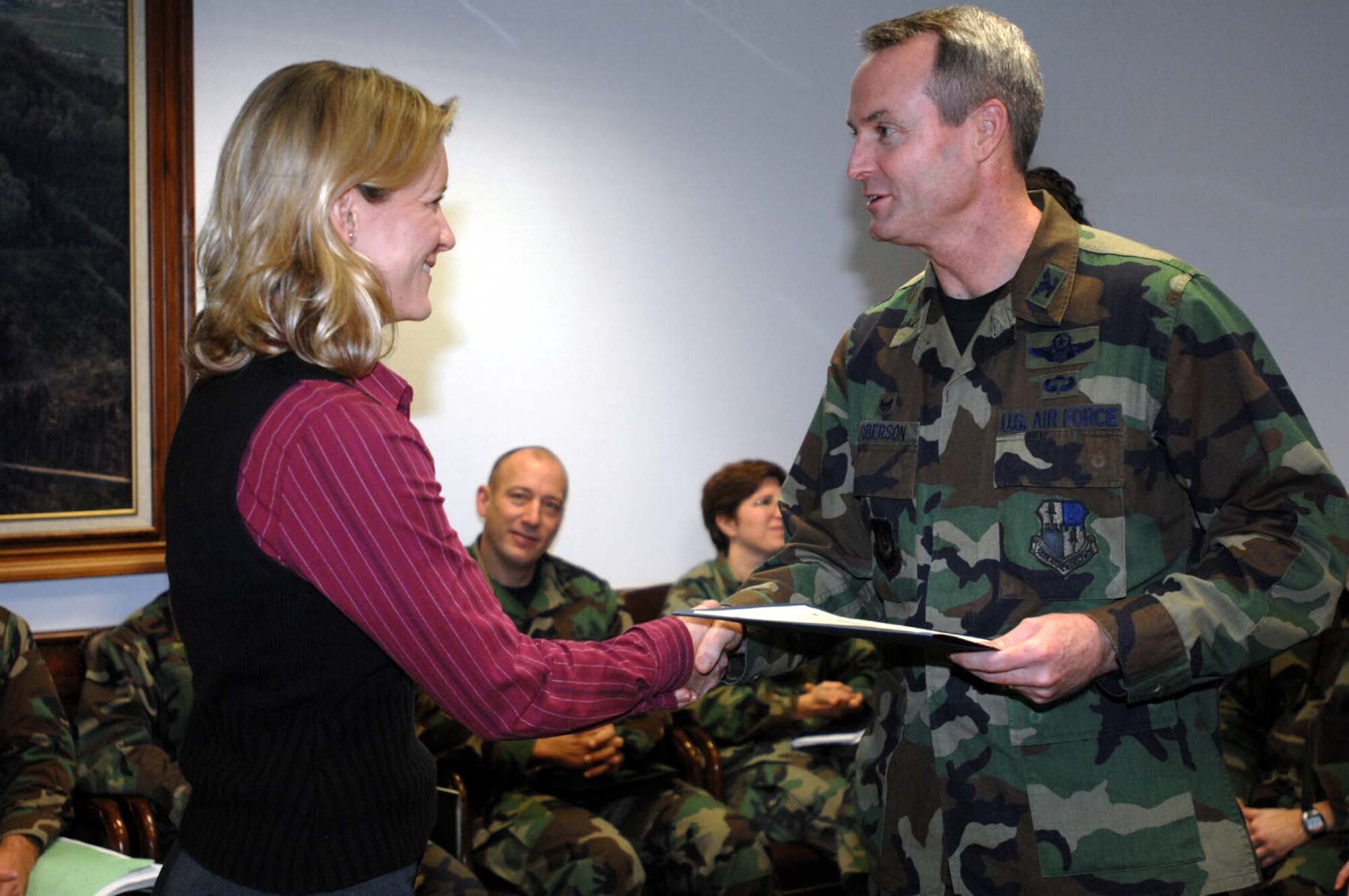 SPANGDAHLEM AIR BASE, Germany -- Ann Lincoln, 52nd Civil Engineer Squadron,  is recognized by Col. Darryl Roberson, 52nd Fighter Wing commander, for superior performance during an Environmental, Safety, Occupational Health, Compliance Assessment and Management Program Assessment Dec. 12, 2007. (U.S. Air Force photo/Airman 1st Class Jenifer Calhoun)