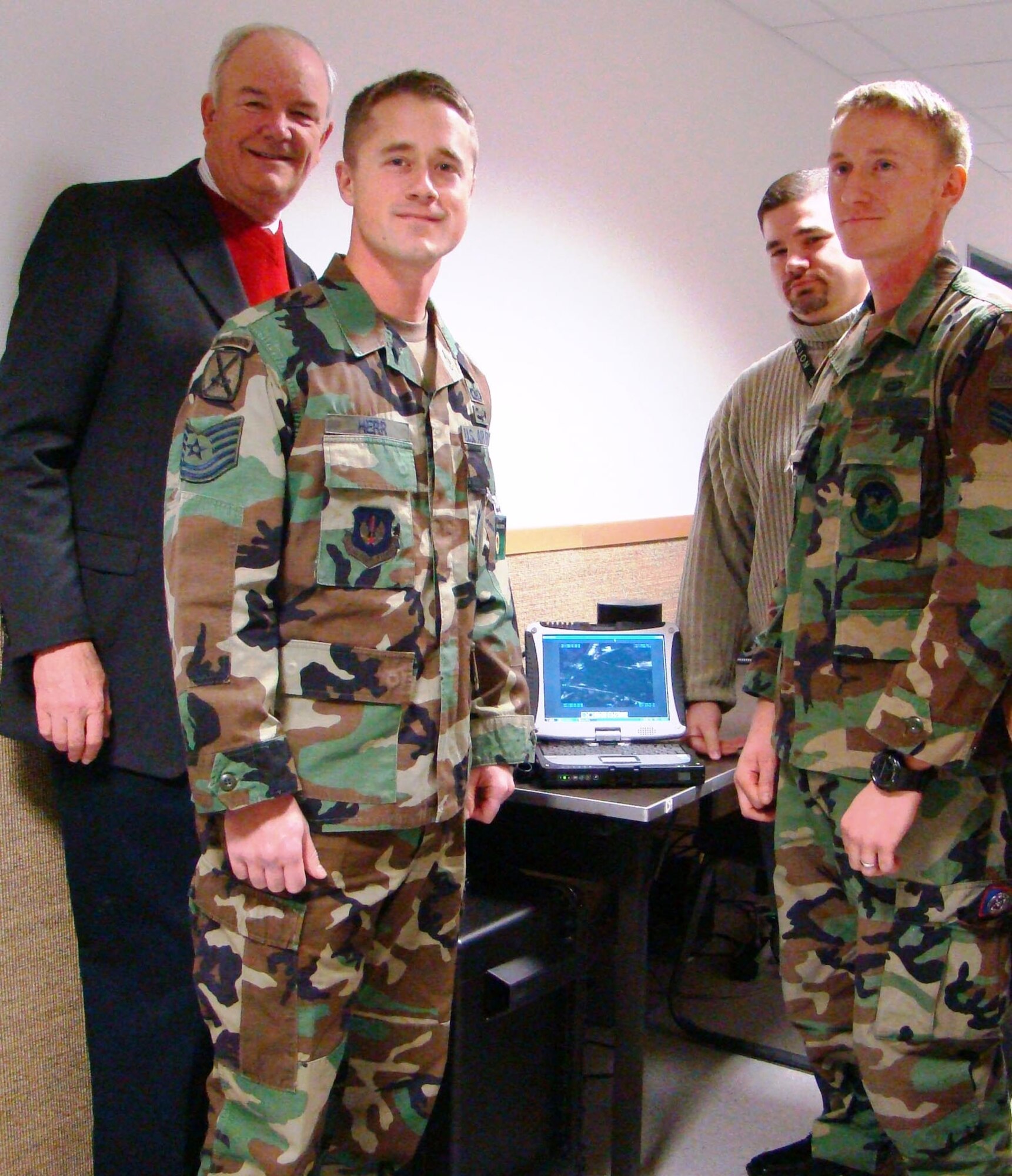 (Left to right) Secretary of the Air Force Michael W. Wynne, Tech. Sgt. Raymond Herr, Mr. Ron Allen (WPC contractor) and Senior Airman Michael Wilhelm. The Secretary visited U.S. Air Forces in Europe’s Warrior Preparation Center here to see a demonstration of the ROVER training program Dec. 12. (Courtesy photo)