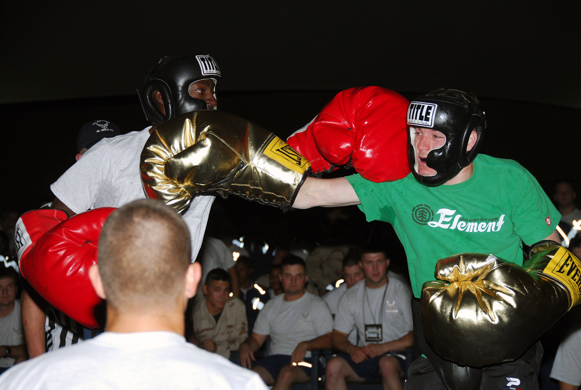 SOUTHWEST ASIA - Staff Sgt. Reginald Johnson, 379th Expeditionary Maintenance Squadron, and Gareth Nutley, Royal Air Force, exchange blows in a boxing match hosted by the , Desert 5 at a Southwest Asia air base. The Friday Night Fights boxing event was at Memorial Plaza Dec. 14. (U. S. Air Force photo/Staff Sgt. Douglas Olsen)