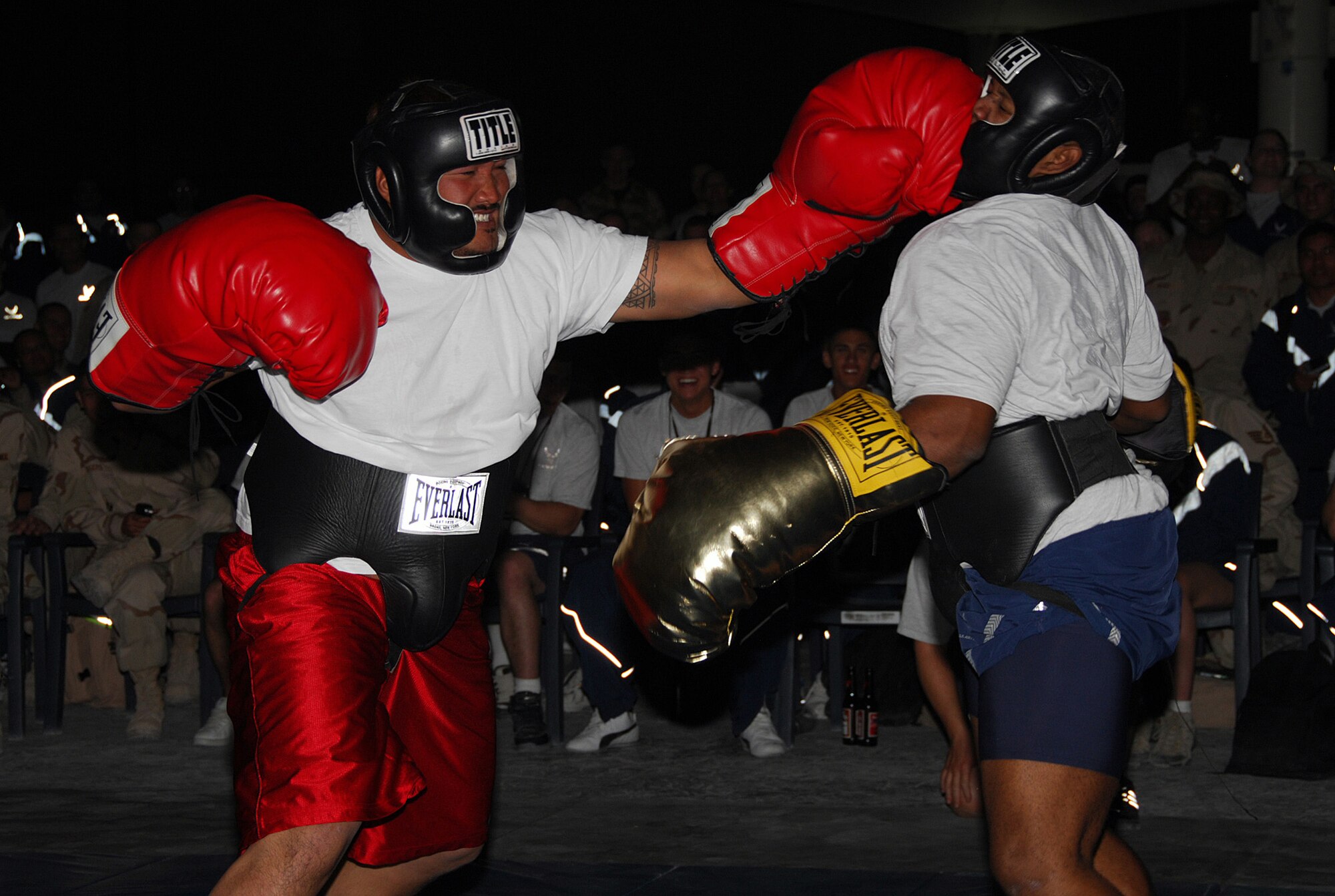 SOUTHWEST ASIA - The Big Kahuna delivers a left to the head of Staff Sgt. Leon Johnson, 379th Expeditionary Maintenance Squadron, in a boxing match hosted by the Desert 5 at a Southwest Asia air base Dec. 14. (U. S. Air Force photo/Staff Sgt. Douglas Olsen)