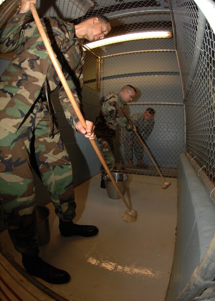 SEYMOUR JOHNSON AIR FORCE BASE, N.C. - Captain Michael Myers and Captain Kevin Humphrey, Chaplains, 4th Fighter Wing, scrub dog kennels on December 13. Capt Michael Myers and Capt Kevin Humphrey, often do outreach events to boost moral and to get to know 4th Fighter Wing Personnel. (U.S. Air Force photo by Airman 1st Class Jonathon Williams)