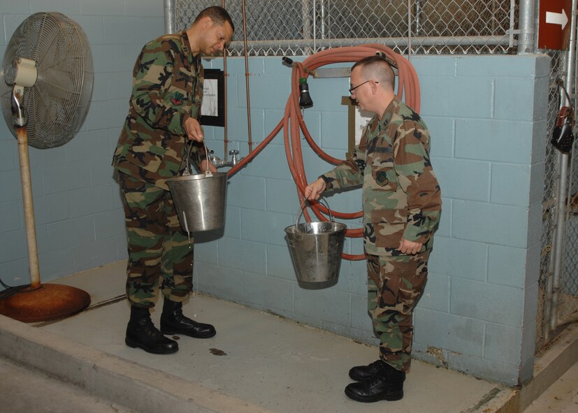 SEYMOUR JOHNSON AIR FORCE BASE, N.C. - Captain Michael Myers and Captain Kevin Humphrey, Chaplains, 4th Fighter Wing, fill water buckets on December 13. Capt Michael Myers and Capt Kevin Humphrey, often do outreach events to boost moral and to get to know 4th Fighter Wing Personnel. (U.S. Air Force photo by Airman 1st Class Jonathon Williams)