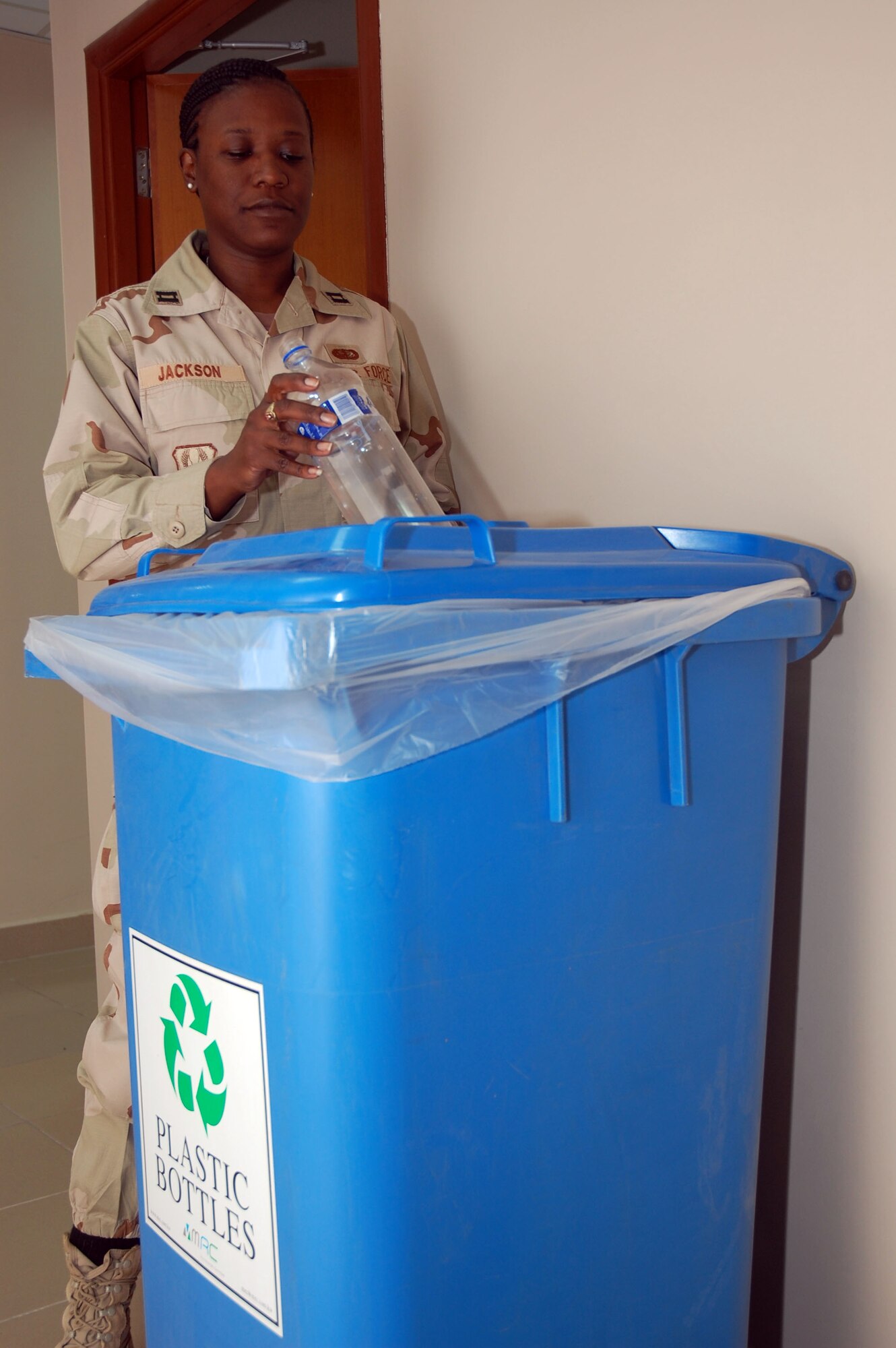 SOUTHWEST ASIA – Capt. Stephanie Jackson places a bottle in a recycling bin Dec. 17 at one of many locations on base. Captain Jackson, 386th Air Expeditionary Wing chief of protocol, is from Robins Air Force Base, Ga. 