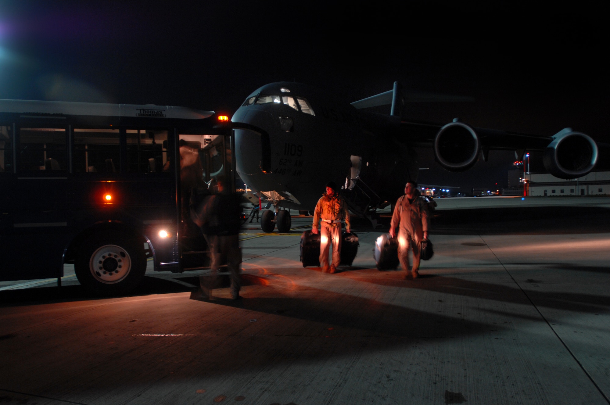 Pilots and crew cheifs unload personal belongings from a C-17 Globemaster III after a long flight from New York to Ramstein Dec. 13. 723rd Air Mobility Squadron members later changed the two front tires on the C-17, loaded it with cargo and launched it to its next destination. (U.S. Air Force photo/Airman 1st Class Kenny Holston)