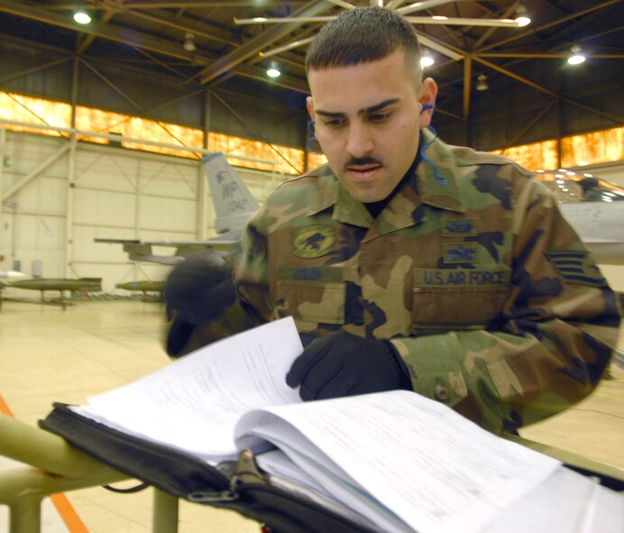 KUNSAN AIR BASE, South Korea -- Staff Sgt. Danny Colon, 8th Aircraft Maintenance Squadron, reviews his checklist during the weapons load competition here Dec. 14.  This was the final weapons load competition between the 80th and 35th Fighter Squadrons for 2007.  (U.S. Air Force photo/Senior Airman Steven R. Doty)