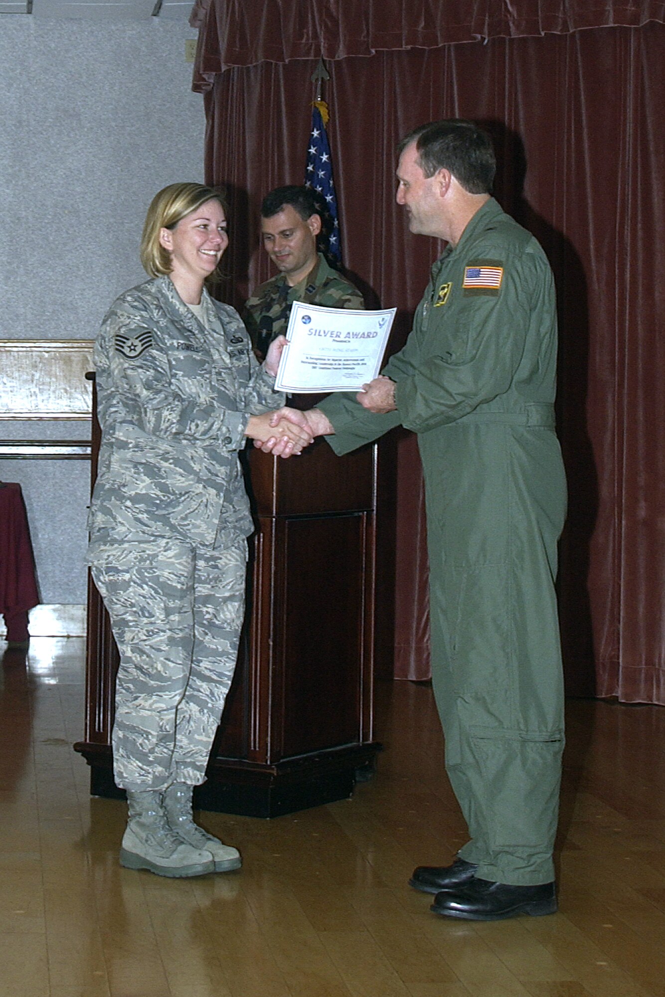 Brig. Gen. Douglas Owens, 36th Wing commander, presents Staff Sgt. Jamie Powell, 36th Wing Staff, with a unit Silver Award for helping the Wing Staff surpass their 2007 Combined Federal Campaign goal.  The Wing Staff raised more than $10,000 for CFC.