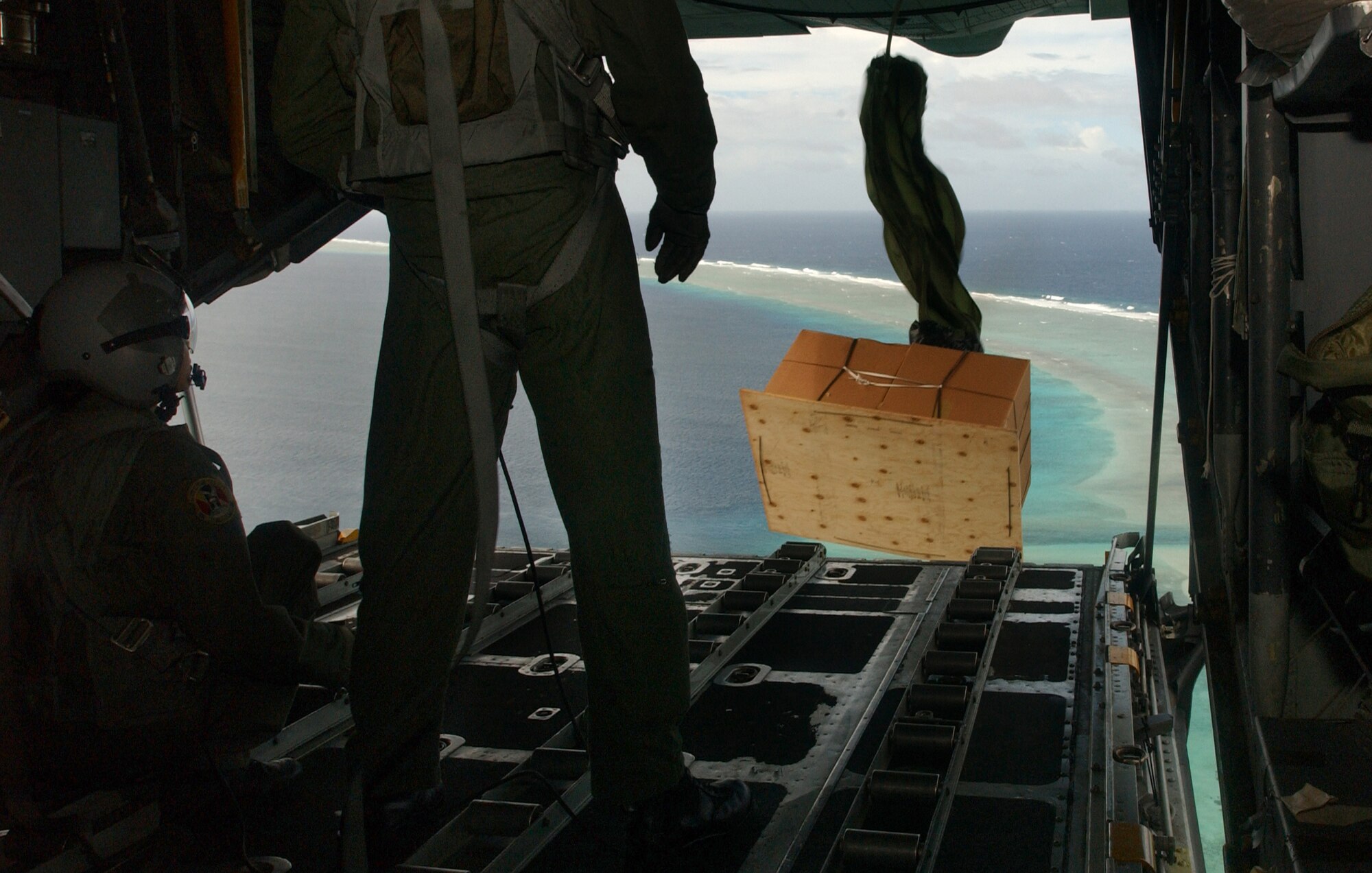 In support of Operation Christmas Drop, three C-130 Hercules flew over islands in the Western Pacific and Micronesia area Dec. 14 through 18 to deliver pallets containing several pounds of toys, holiday decorations and other donated items to help spread the holiday spirit. (U.S. Air Force photo/Senior Airman Brian Kimball)