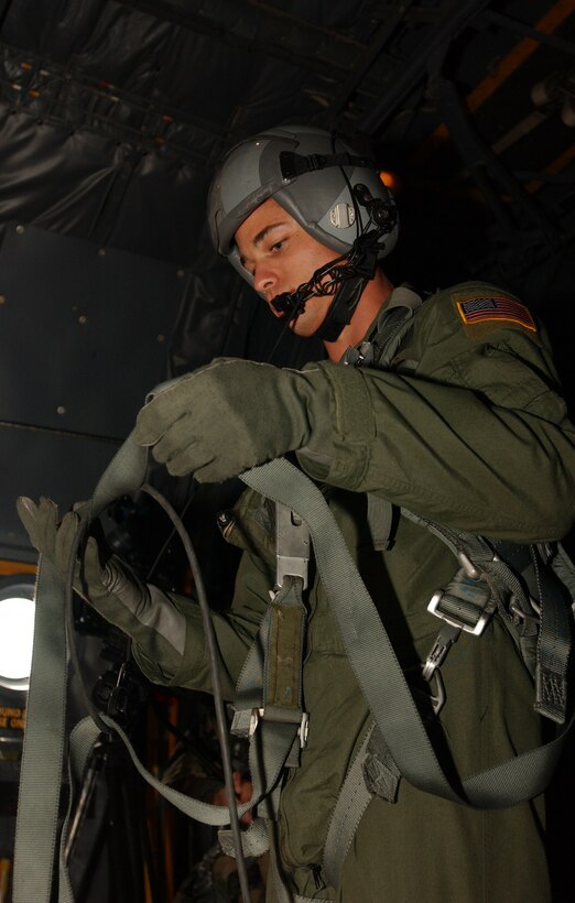 Senior Airman Joshua Coda, 36th AS, organizes his traps prior to unloading the pallets during Operation Christmas Drop. The C-130 Hercules’ aerial delivery capability not only make it a great force multiplier by getting supplies and ammunition anywhere on the battlefield; it can also be used to provide holiday cheer to America’s neighbors in the Western Pacific region. (Air Force photo/Senior Airman Brian Kimball)  
