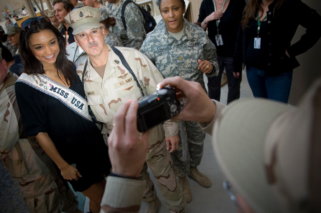 Miss USA Rachel Smith poses for a photo with a servicemember at the 2007 USO Holiday Tour, at Camp Arifjan, Kuwait, Dec. 17, 2007. 