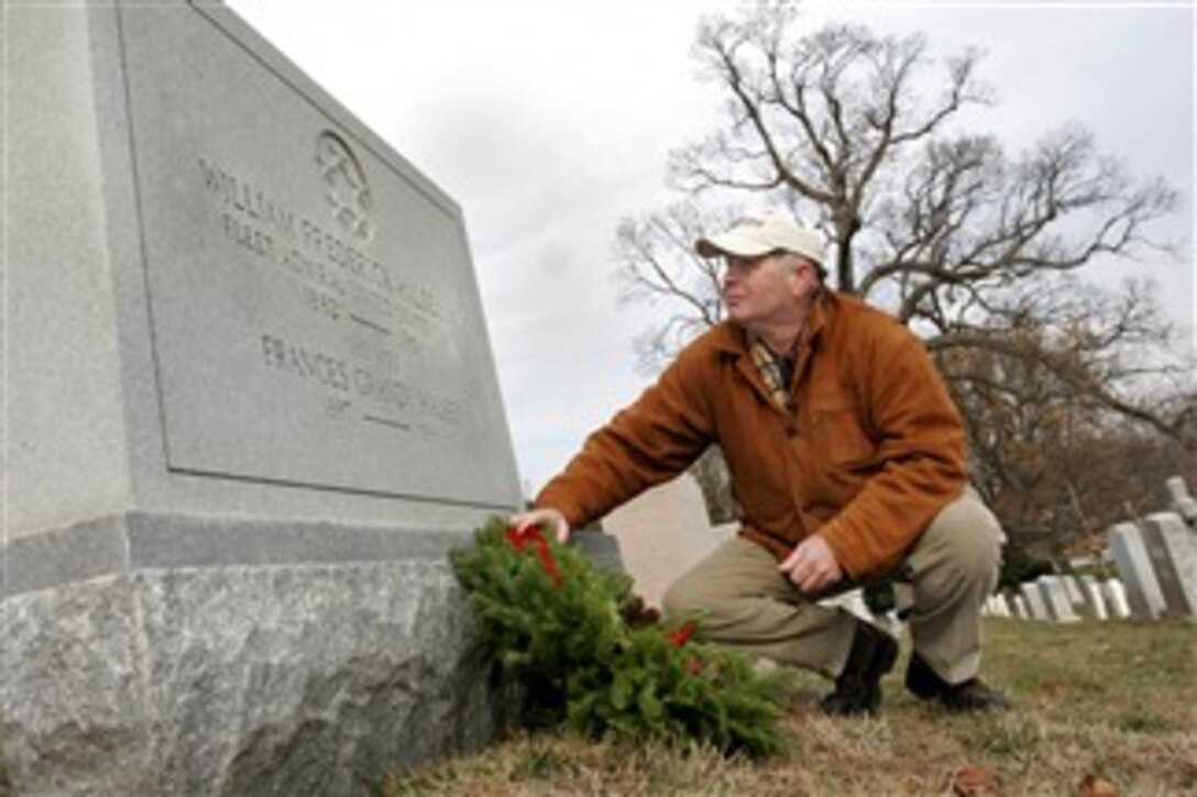 Morrill Worcester, owner of Worcester Wreath Company in Harrington, Maine, lays a wreath at the grave of U.S. Navy Adm. William "Bull" Halsey at Arlington National Cemetery, Dec. 15, 2007. Worcester donated more than 10,000 wreaths to the cemetery in an annual project he started to honor and remember veterans.
