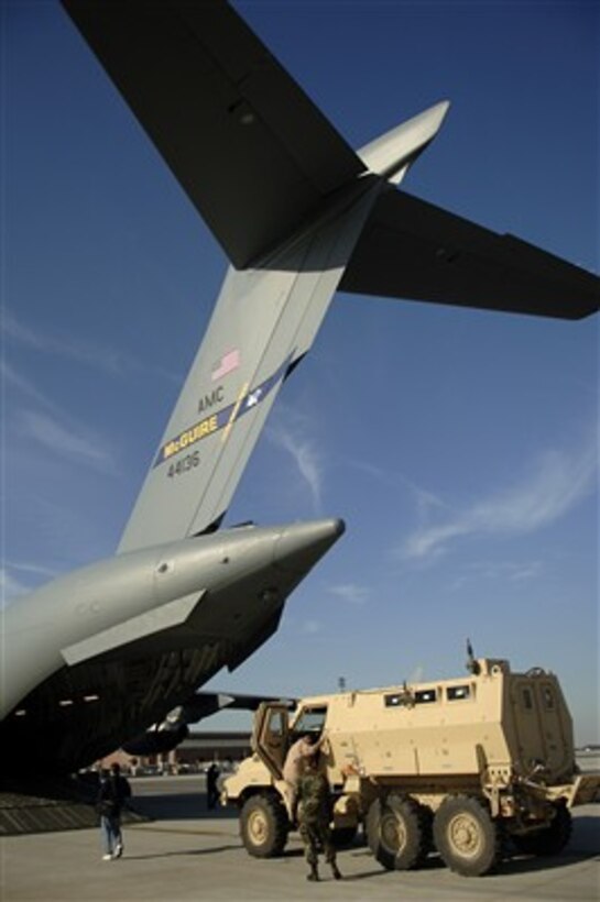 U.S. Air Force airmen from the 437th Aerial Port Squadron prepare to load a Mine Resistant Ambush Protected (MRAP) vehicle into a C-17 Globemaster III aircraft at Charleston Air Force Base, S.C., on Dec. 7, 2007.  Airmen from the 732nd Airlift Squadron at McGuire Air Force Base, N.J., will transport the vehicle to Iraq.  