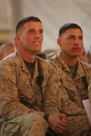 AL TAQADDUM, Iraq (Dec. 18, 2007) ? Cpls. Seth T. Snyder (left) and Christopher L. Marquez watch as comedian Lewis Black performs on stage as part of a United Service Organization tour here Dec. 18.  Black, along with Robin Williams, Miss USA Rachel Smith, Kid Rock and Lance Armstrong, came to visit troops during the holiday season.  The celebrities will continue their tour throughout the season making additional stops in Iraq and Afghanistan.  Snyder is a motor transportation maintenance mechanic and Oakdale, Minn., native with Headquarters Company, 2nd Marine Logistics Group (Forward).  Marquez is an administration clerk and Elizabethtown, Ky., native with Headquarters Company, 2nd MLG (Fwd).