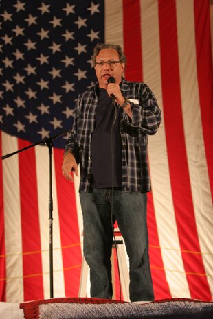 AL TAQADDUM, Iraq (Dec. 18, 2007) ? Comedian Lewis Black performs on stage for U.S. servicemembers as part of a United Service Organization tour here Dec. 18.  Black, along with Robin Williams, Miss USA Rachel Smith, Kid Rock and Lance Armstrong, came to visit troops during the holiday season.  The celebrities will continue their tour throughout the season making additional stops in Iraq and Afghanistan.