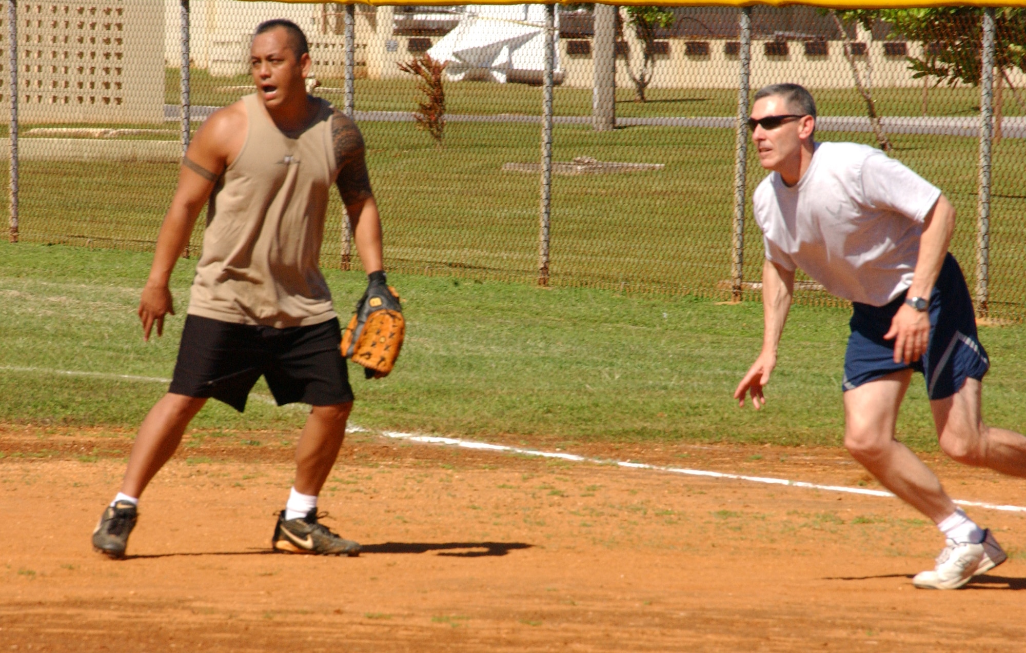 Lt. Col. John Vitacca, 393rd EBS commander, takes off from first base after a teammate rifles a shot toward left-center field. The rules were modified to ensure every competing team had a chance to play. Players were allowed to pitch to their own team, but the challenge lay in the fact every pitch had to be swung at. If the batter failed to connect, he was retired. Each team was allowed fifteen pitches total for one inning each. (Air Force photo/Tech. Sgt. Steven Wilson)  