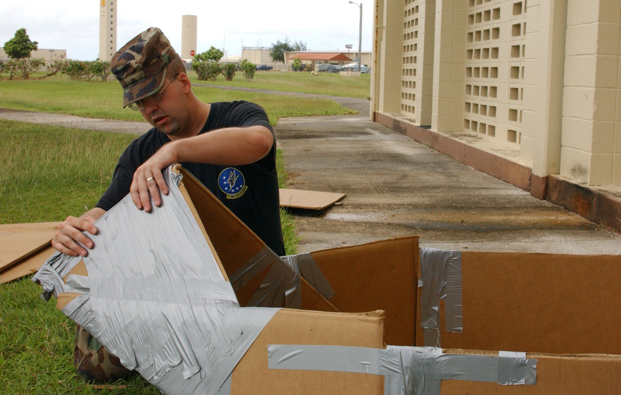 Staff Sgt. David Andrews, 393rd EBS combat crew communications specialist, begins taping the tapered bow of what eventually will become the USS Fat Chance. Fat Chance was entered in the Team Andersen Challenge cardboard boat race and finished third. It was the only vessel to have a hull completely ensconced in duct tape. Sergeant Andrews doesn’t recall exactly how much length of tape he used, but did say it “was about $15 worth.” (Air Force photo/Tech. Sgt. Steven Wilson)