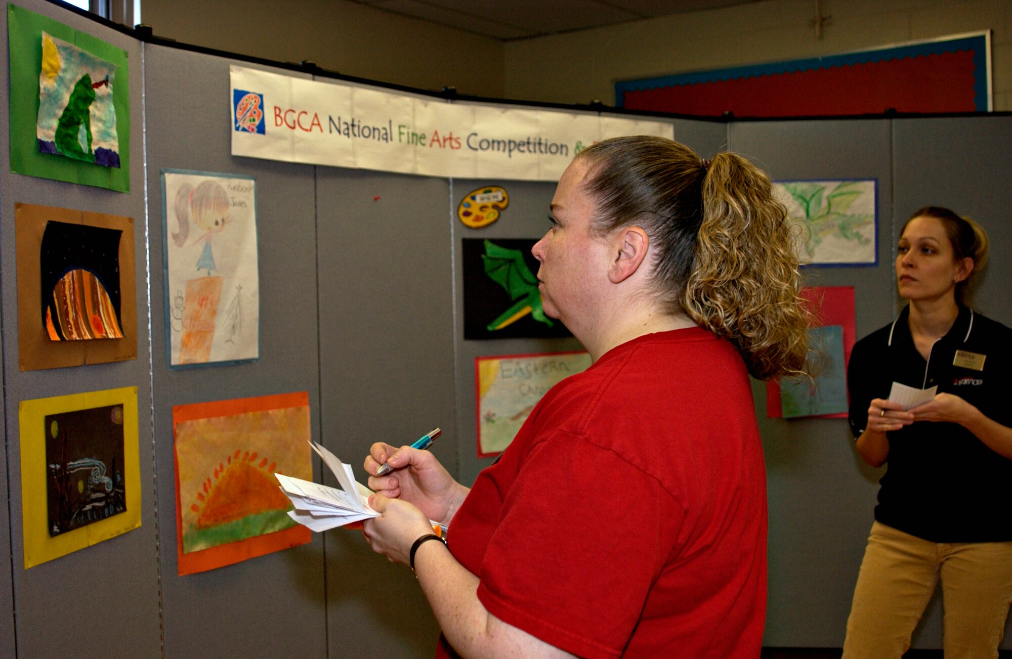 Ms. Kelly Miles (left), a recreational assistant at the Lunney Youth Center, and Ms. Jade Schuler (right), with services marketing, are judges during the 2008 National Fine Arts competition Dec. 10. (U.S. Air Force photo by Senior Airman Stefanie Torres)     