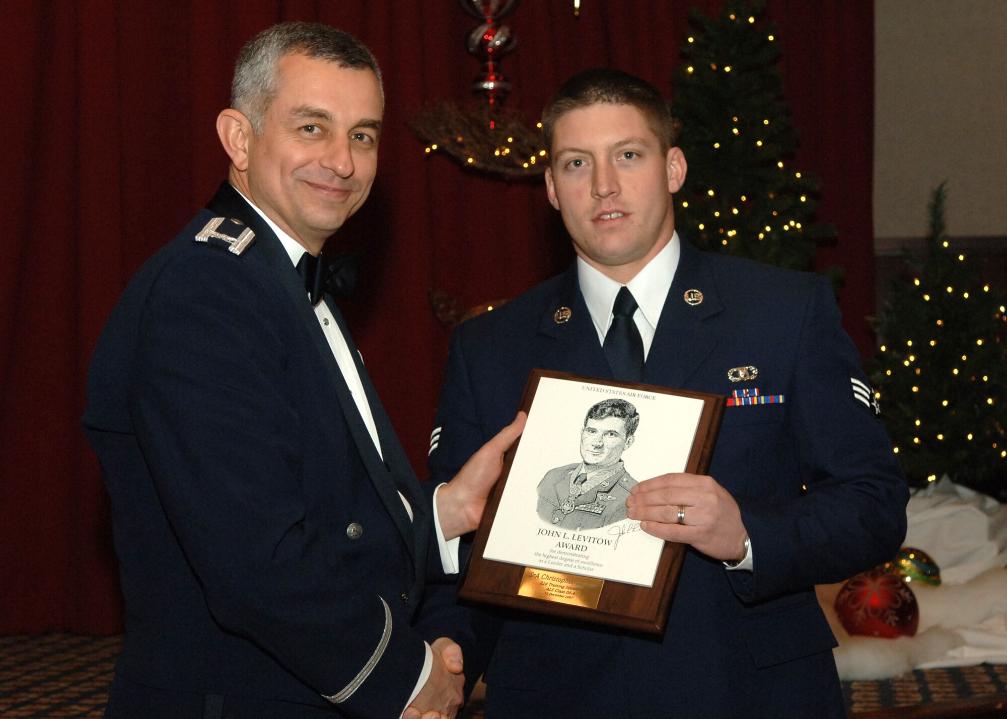 FAIRCHILD AIR FORCE BASE, Wash. -- Col. Roger Watkins, 92nd Air Refueling Wing vice commander, presents the John L. Levitow Award to Senior Airman Christopher DeLange of the 22nd Training Squadron at the Airman Leadership School graduation Dec. 13. The Levitow Award is the highest honor in Enlisted Professional Military education, presented to the class’s top student. (U.S. Air Force photo/Senior Airman Jocelyn A. Ford)