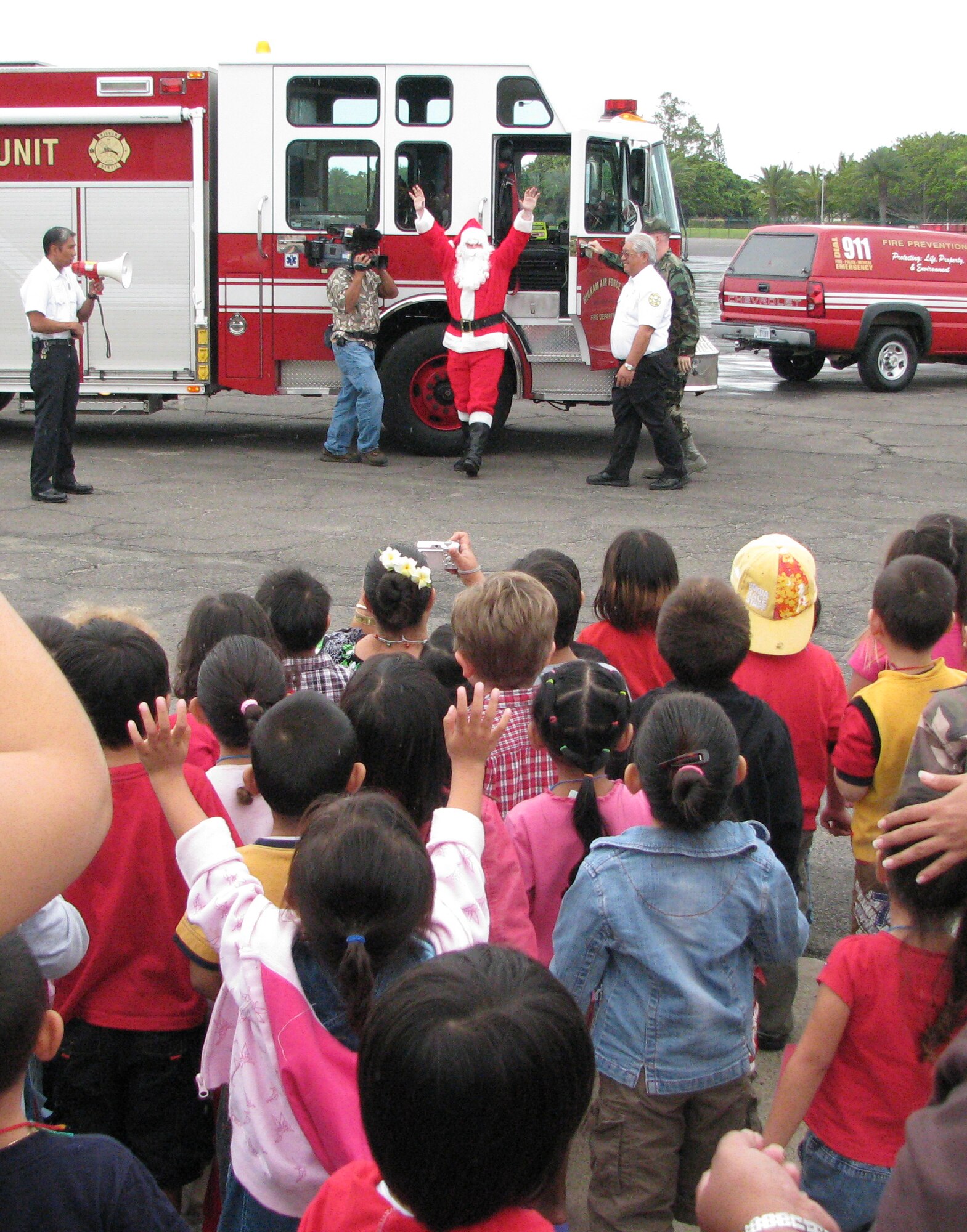 Children greet  Santa upon his arrival at Bldg 2115 for the Head Start Holiday Partyhosted by the 15th Mission Support Group here. The group raised money through various fundraisers to put together a holiday party complete with gifts for the children as well as classroom supplies for the teachers. Photo by Staff Sgt. Erin Smith