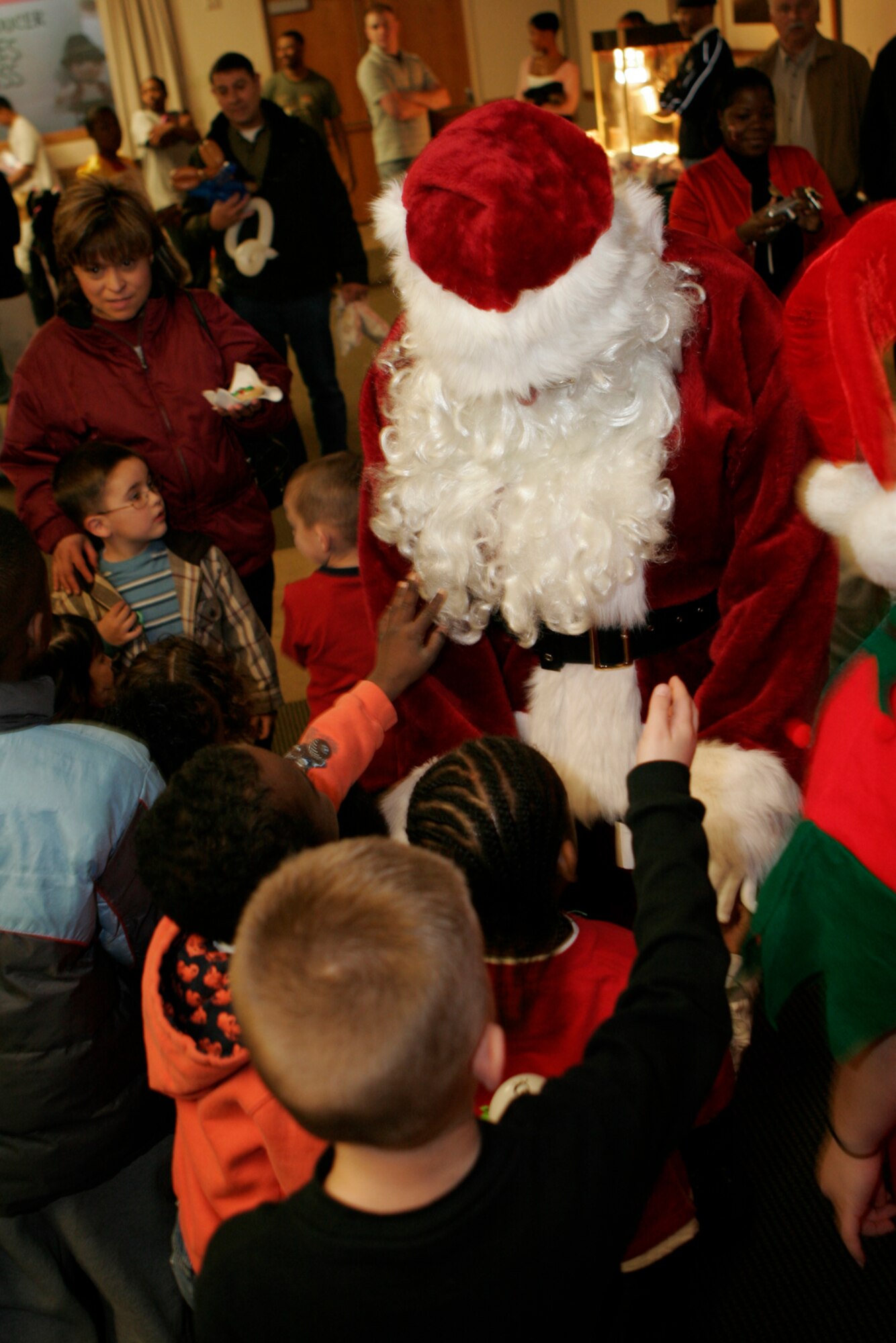 Santa Claus makes an appearance at the 99th Air Base Wing Commander’s Children’s Holiday Party, held at the officer’s club Dec. 15. Nellis and Creech families brought more than 300 children to the event to enjoy activities such as games, raffles, cookie decorating and face painting. (U.S. Air Force photo by Staff Sgt. Jacob R. McCarthy)