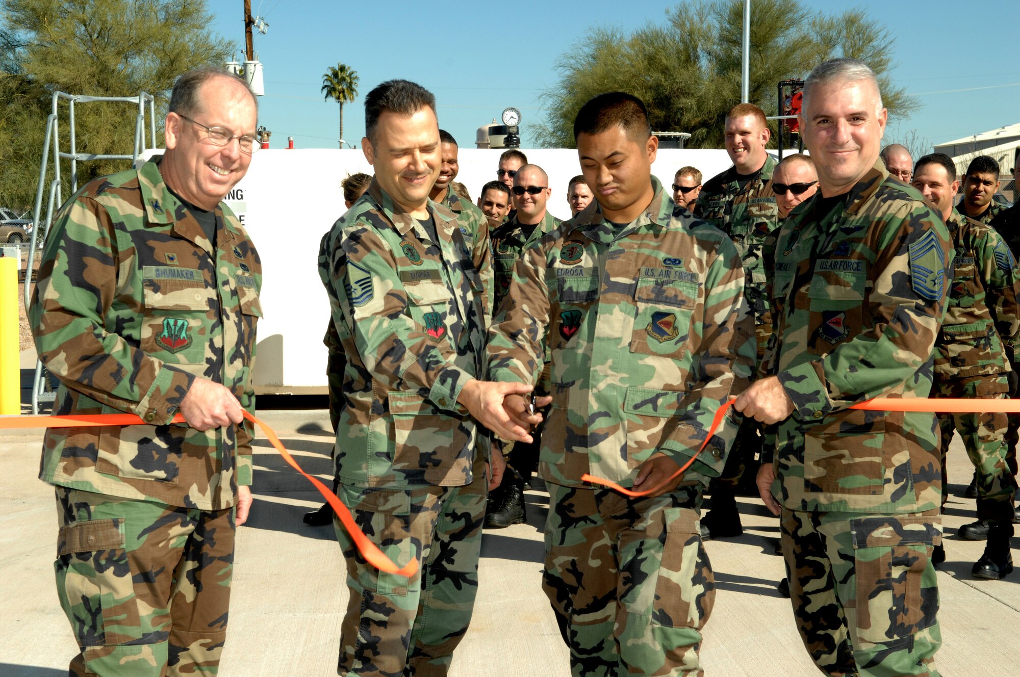 Col. Dennis Shumaker, 355th Maintenance Group commander, Master Sgt. Stephen Daigle, 355th Equipment Maintenance Squadron Aerospace Ground Equipment flight chief, Airman 1st Class Eddie Edrosa, 355th Equipment Maintenance Squadron AGE journeyman and Chief Master Sgt. Kevin Barnhill, 355th Maintenance Group superintendent participate in the ribbon cutting ceremony Dec. 17 for the new fuel tank located on the flightline here. The new fueling station is an Air Force Smart Operation 21 initiative, which will drastically reduce the amount of time required for maintenance personnel to refuel aircraft stationed here.  (U.S. Air Force photo by Airman 1st Class Melissa Copeland) 