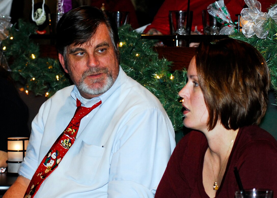Steve Hannan and Tech. Sgt. Jesse Fields enjoy the ARPC Holiday Party on Dec. 14. More than 250 people attended this year's party at the Lowry Tavern's Soiled Dove. (U.S. Air Force photo/Ellen Edwards)