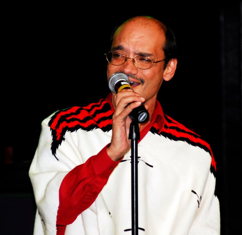 Dave Arnold dons a serape for his ARPC Idol performance at the holiday party Dec. 14. More than 250 people attended this year's party at the Lowry Tavern's Soiled Dove. (U.S. Air Force photo/Ellen Edwards)