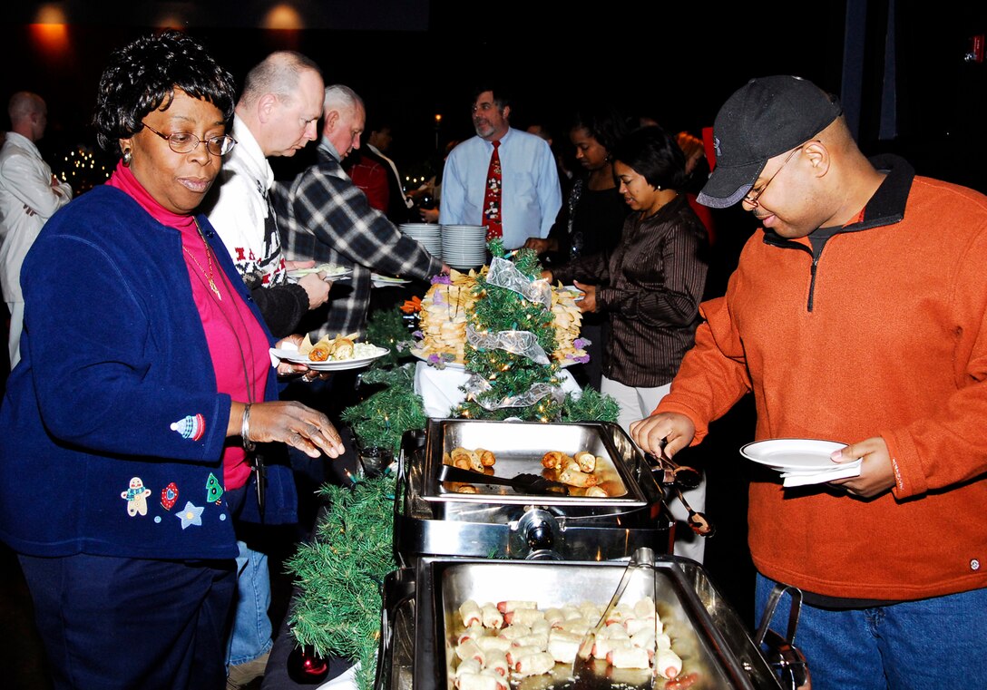 Edith Wallen-Sanchez and Master Sgt. Damien Maddox sample the fare at this year's ARPC Holiday Party on Dec. 14. More than 250 people attended this year's event at the Lowry Tavern's Soiled Dove. (U.S. Air Force photo/Ellen Edwards)