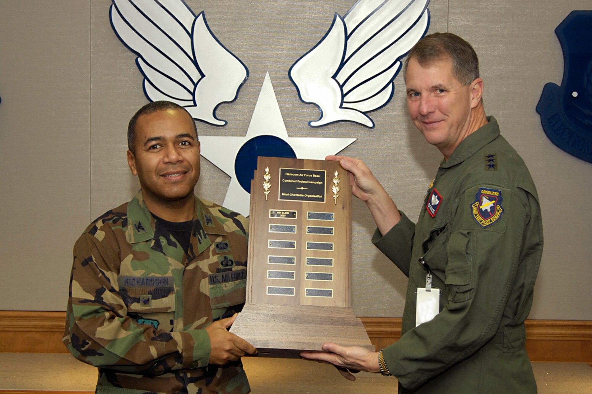 During a senior staff meeting Dec. 14, Electronic Systems Center Commander Lt. Gen. Ted Bowlds (right) presented Col. Derrick Richardson (left), 554th Electronic Systems Wing vice director, with a trophy to recognize the 554th as the Hanscom unit that averaged the largest sum of money donated for the number of people assigned to it for the 2007 Combined Federal Campaign Drive. 
