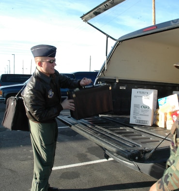 1st Lt. Eric Buss, 12th Missile Squadron combat crew commander,  loads his equipment into the back of a vehicle before deploying to the missile field for an alert. Lieutenant Buss will be deployed to the field during Christmas. (U.S. AIr Force photo/Airman 1st Class Emerald Ralston)