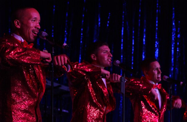 From left to right, Tech. Sgt. Keith Martin, Sr., and Senior Airmen Jonathan Hayden and Nicholas Amari, the Air Force’s expeditionary entertainers perform to a Hangar full of people during the Tops In Blue show here at Hangar 35. Photo by Staff Sgt. Erin Smith